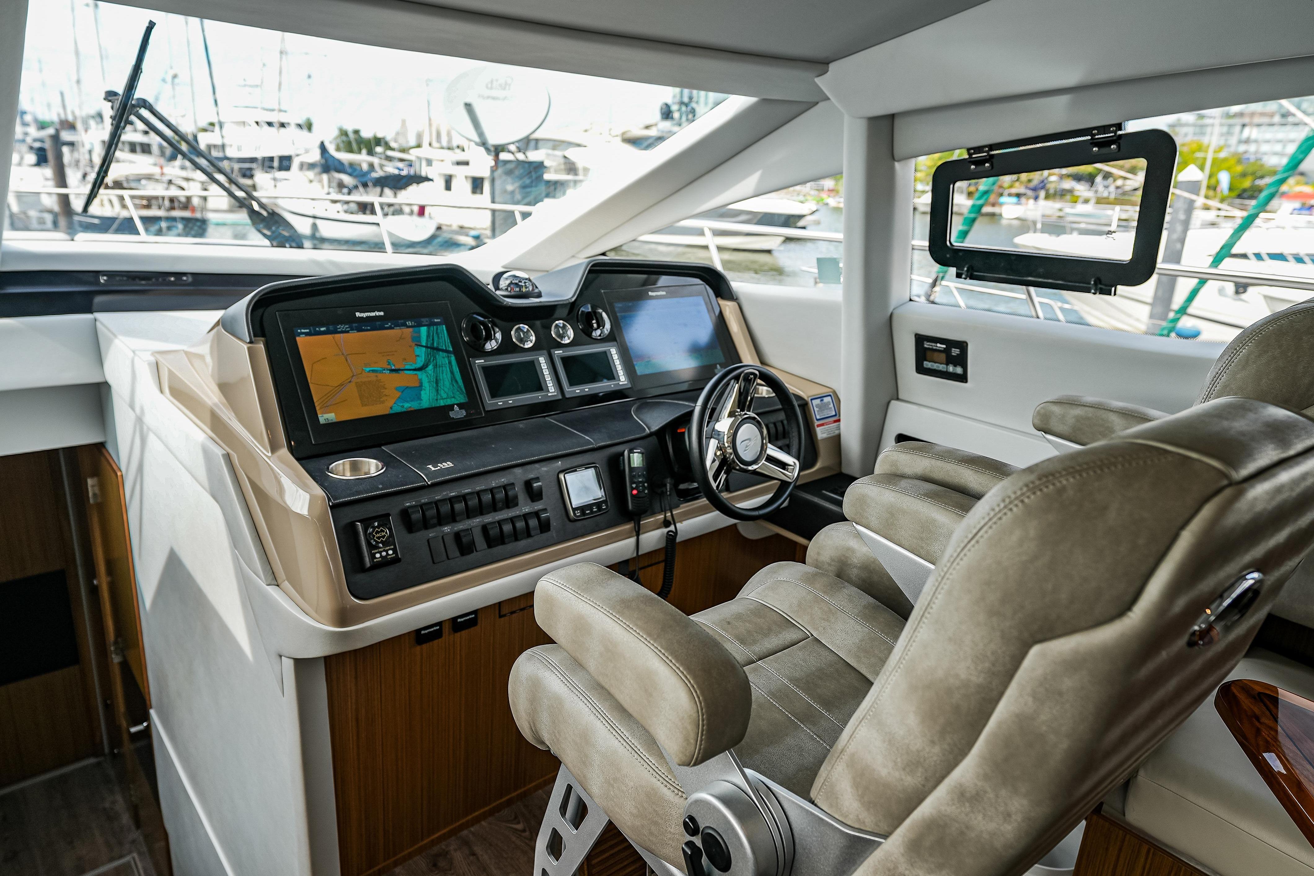 Luxurious helm of 2018 Sea Ray L590 Fly yacht with advanced navigation systems.