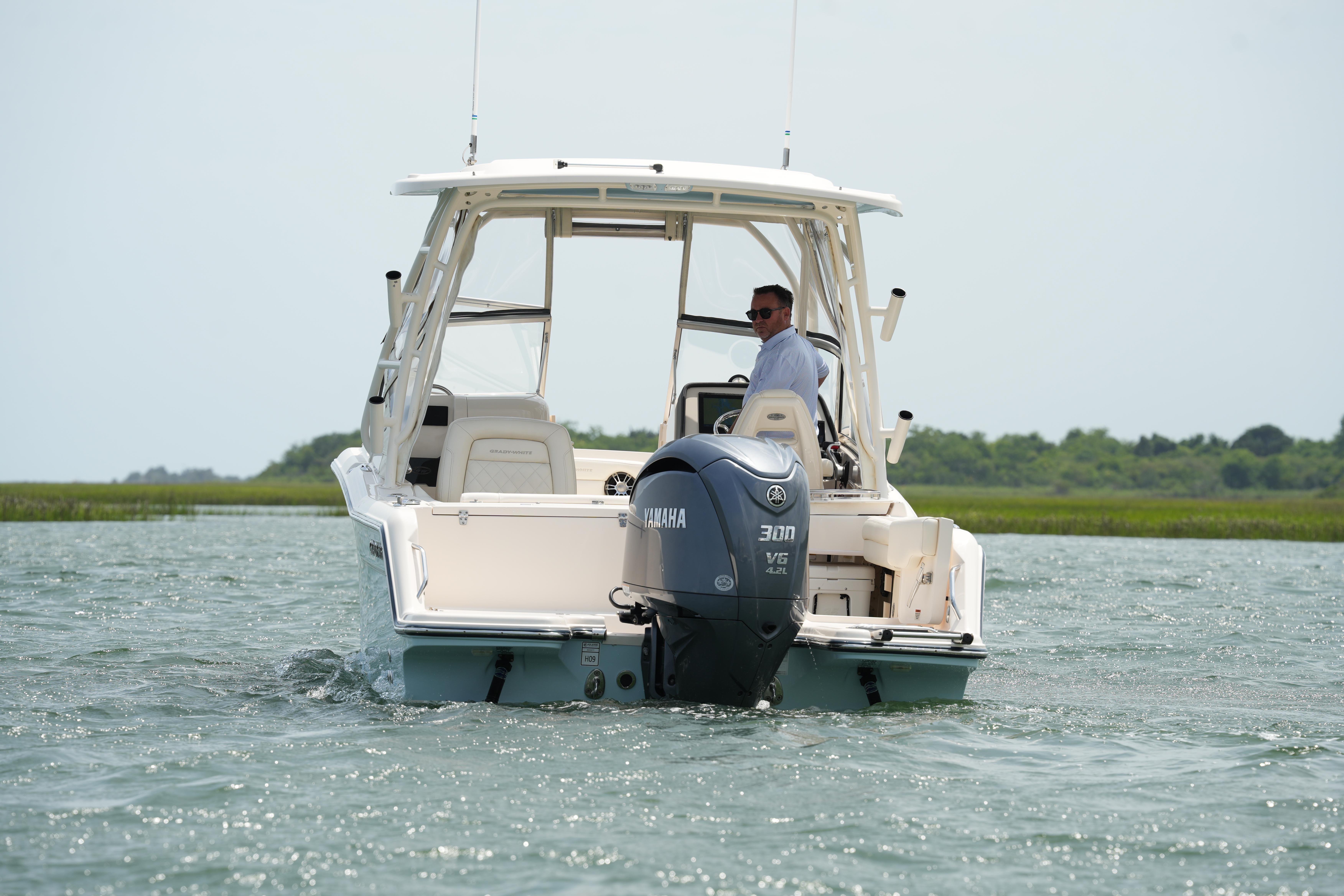 2021 Grady-White Freedom 235 boat with Yamaha engine cruising on water.
