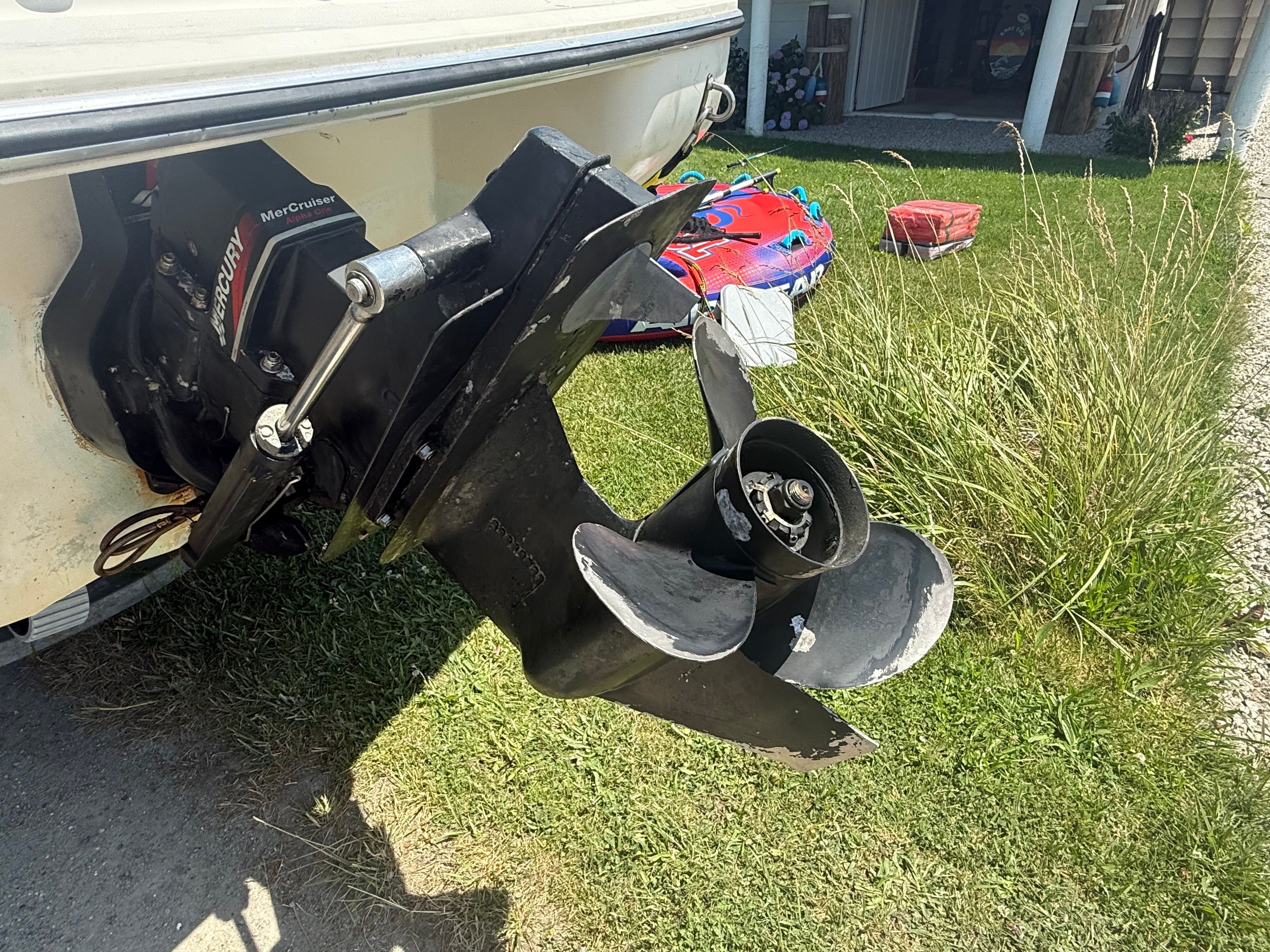 A 2003 Stingray 180 LS/LX with a MerCruiser drive, parked on grass.