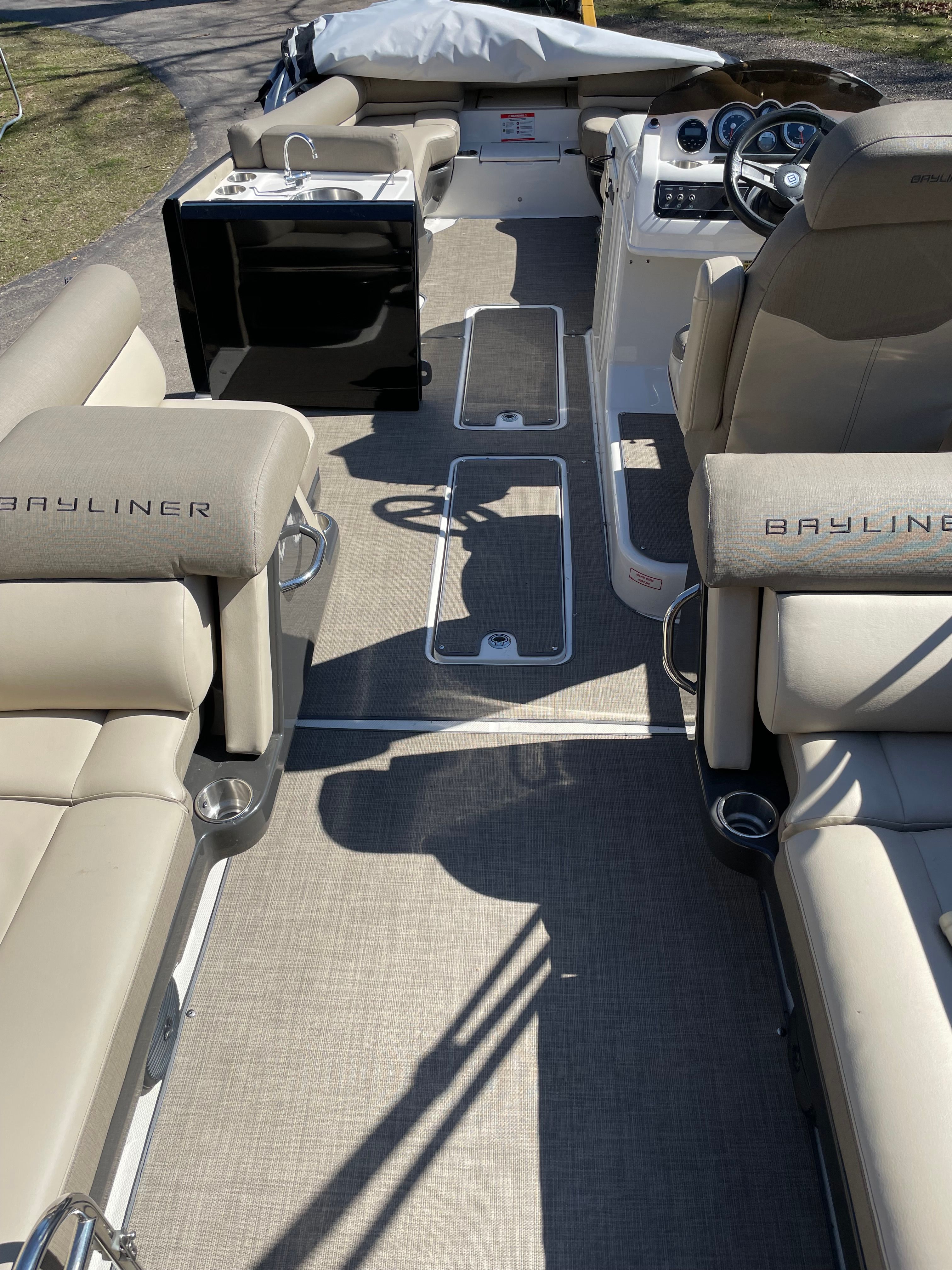 Interior of a 2016 Bayliner Element XR7 with beige seating and a helm console.