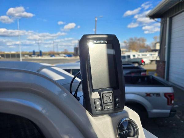 Garmin device on 2025 Berkshire 20 CL boat dashboard, outdoor setting with blue sky.