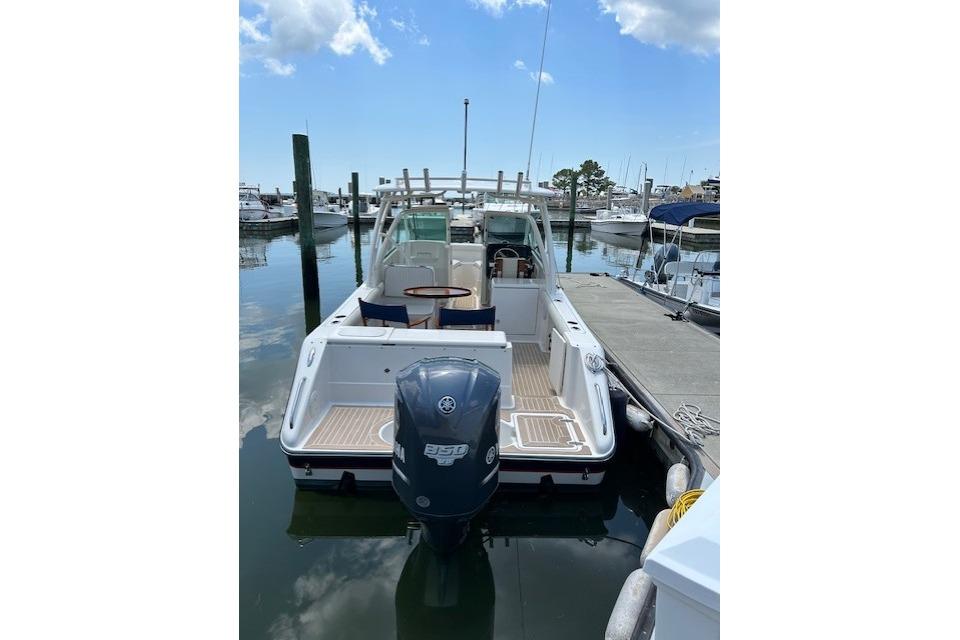 2013 Pursuit DC 265 Dual Console boat docked at marina, rear view with Yamaha outboard.