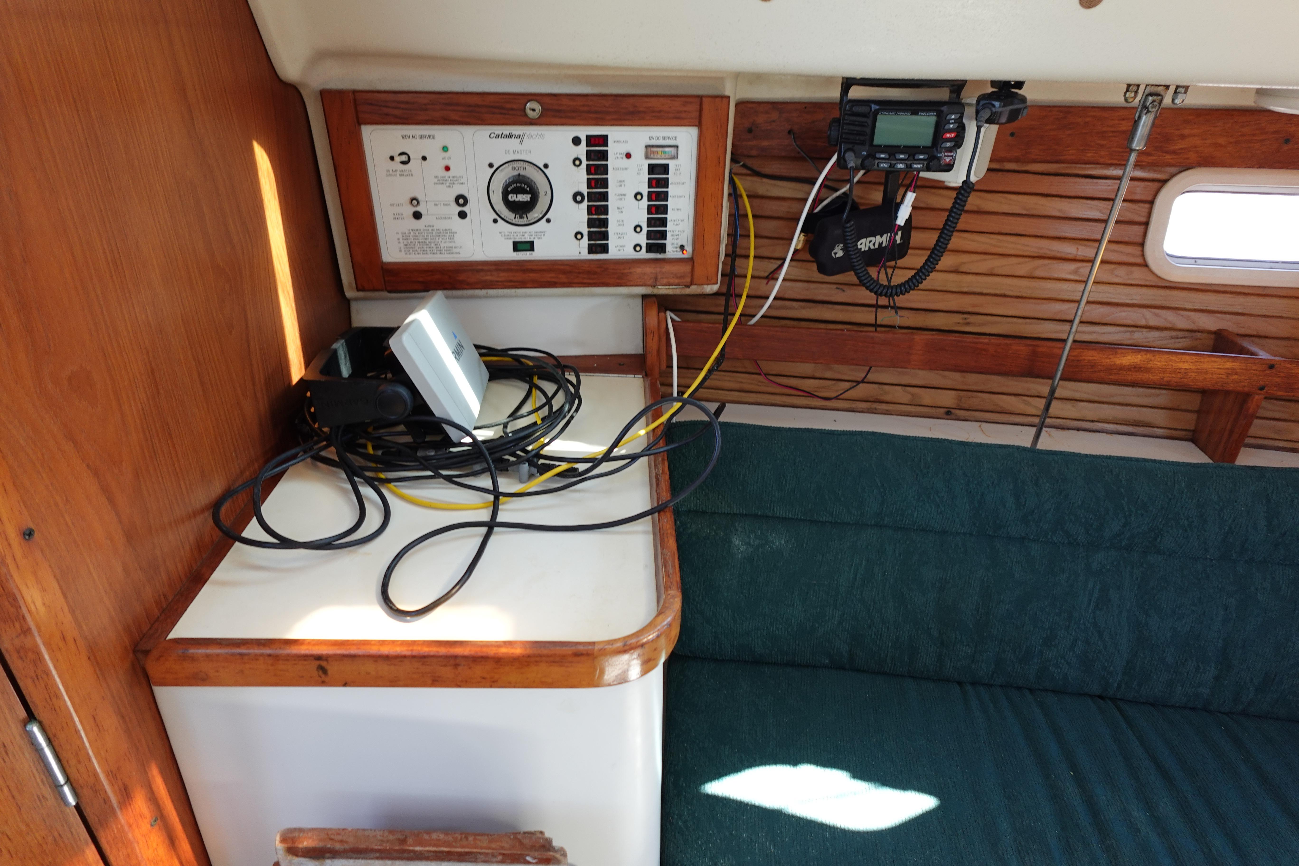 Interior of a 1997 Catalina 28 sailboat with control panel and communication equipment.