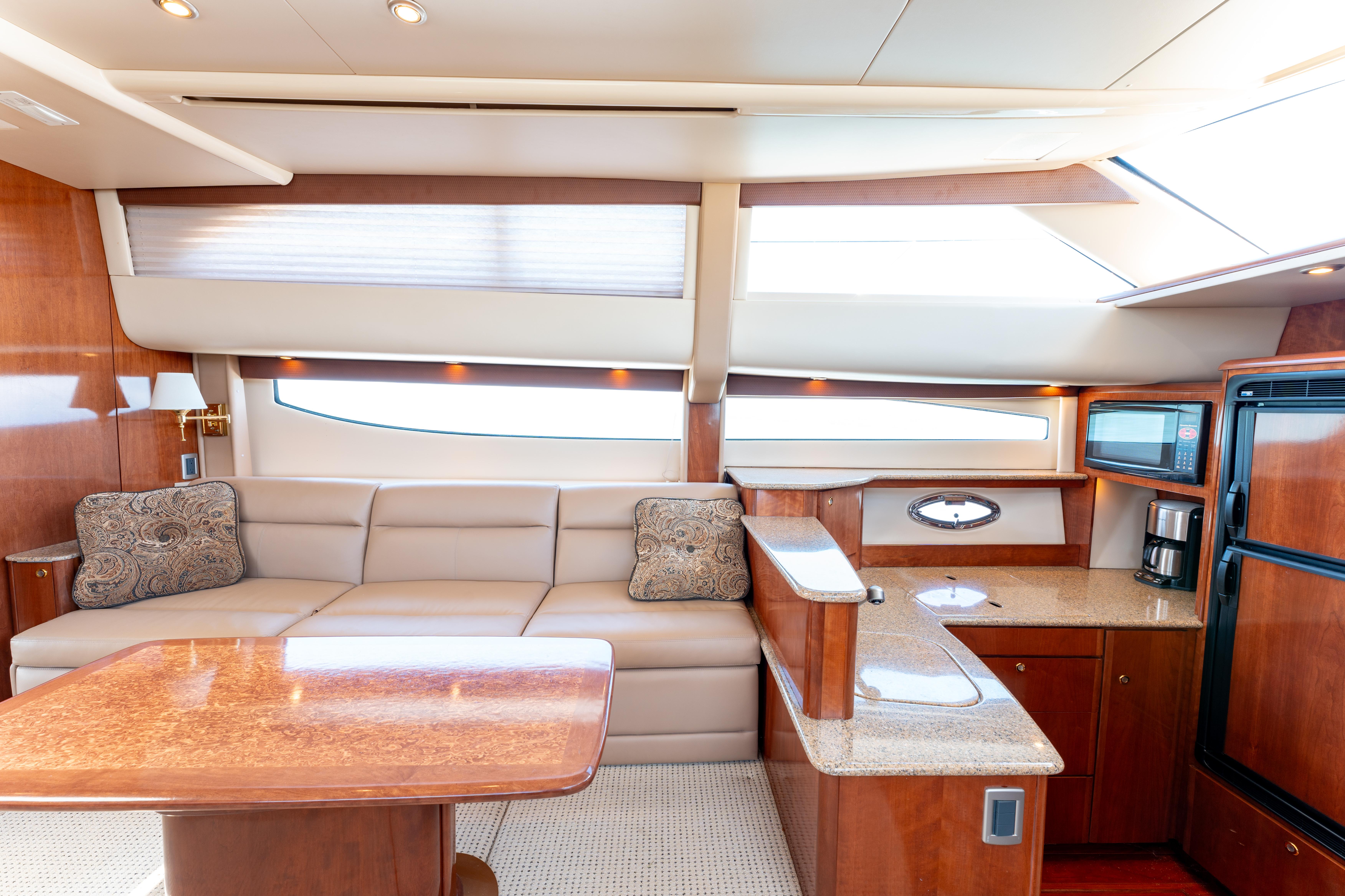 Luxurious interior of 2008 Meridian 459 Motoryacht with plush seating and modern kitchen amenities.