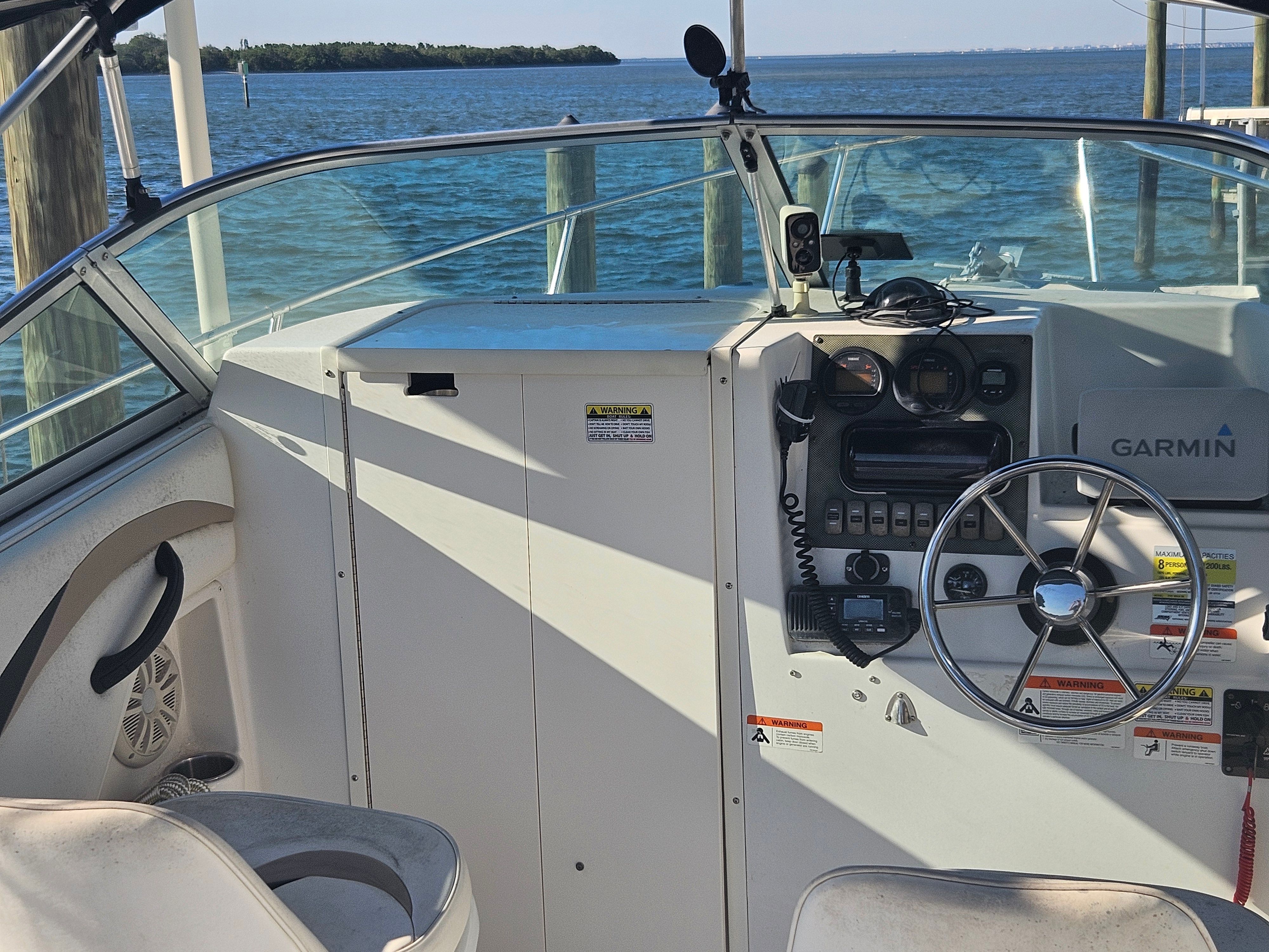 The image shows the cockpit of a 2004 Seaswirl Striper 2101 Walkaround O/B with steering and instruments.