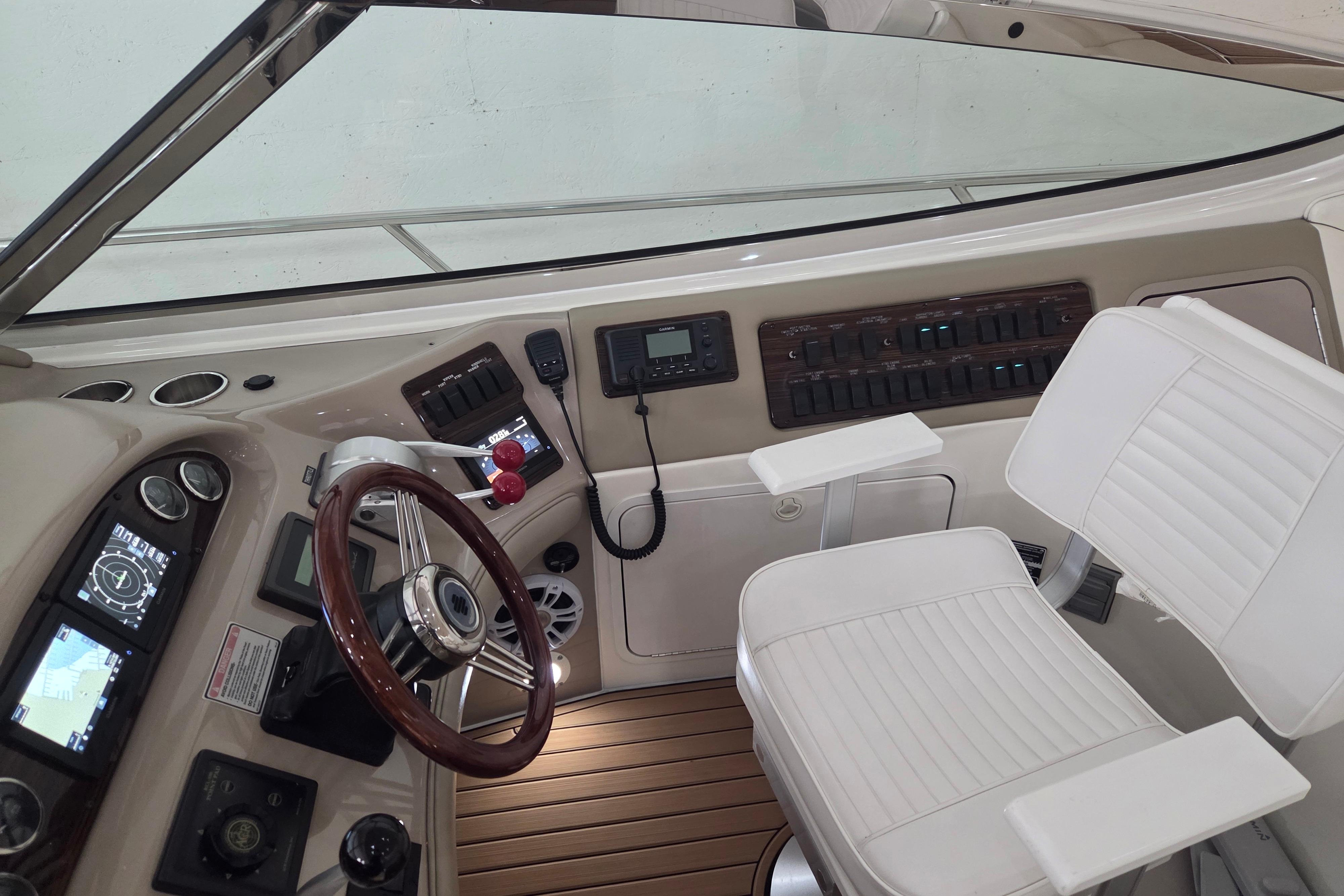 Cockpit of 2000 Sea Ray Sundancer 540 with steering wheel and control panel.