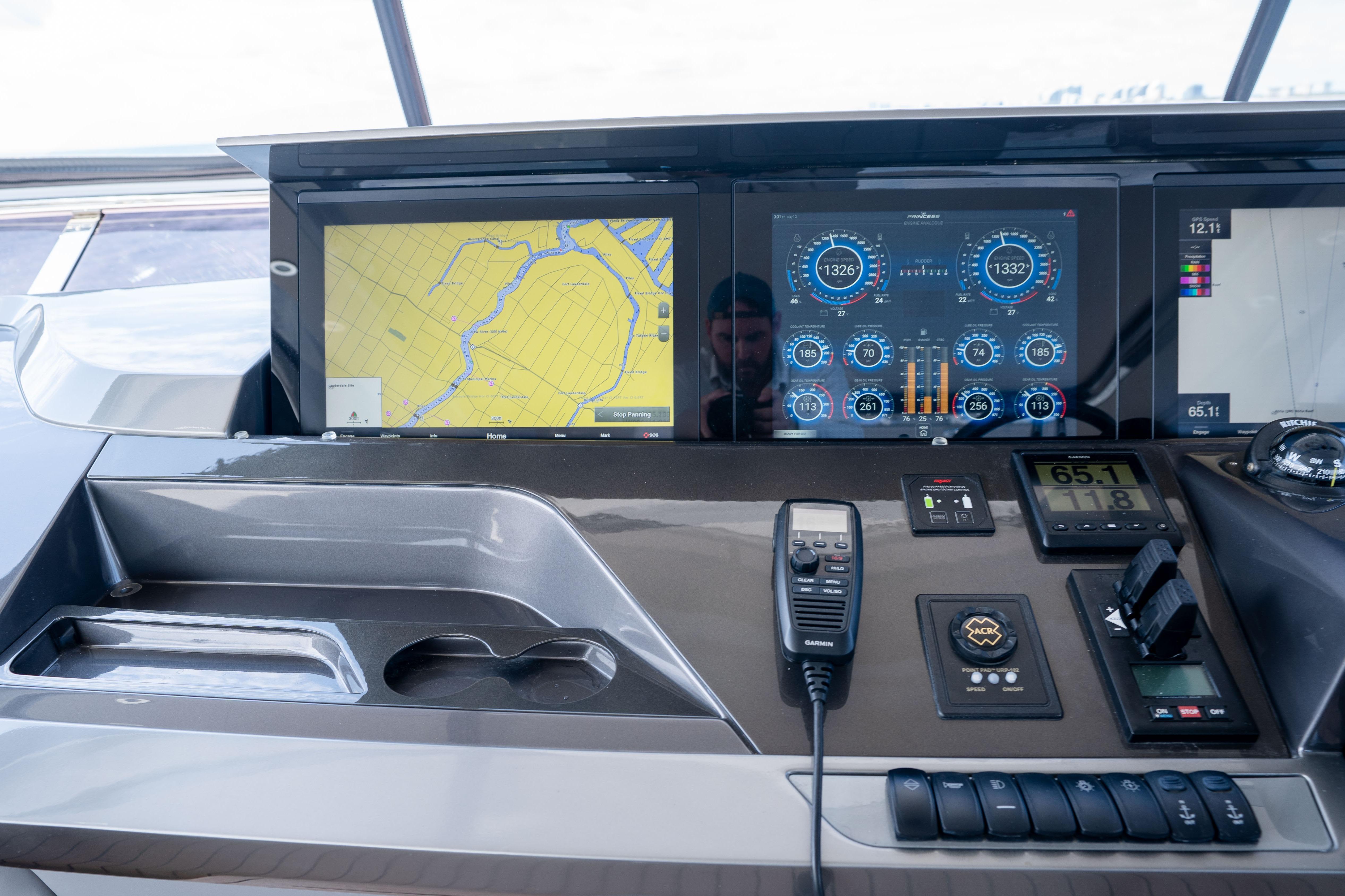 Control panel of a 2020 Princess Y85 yacht with navigation and monitoring displays.