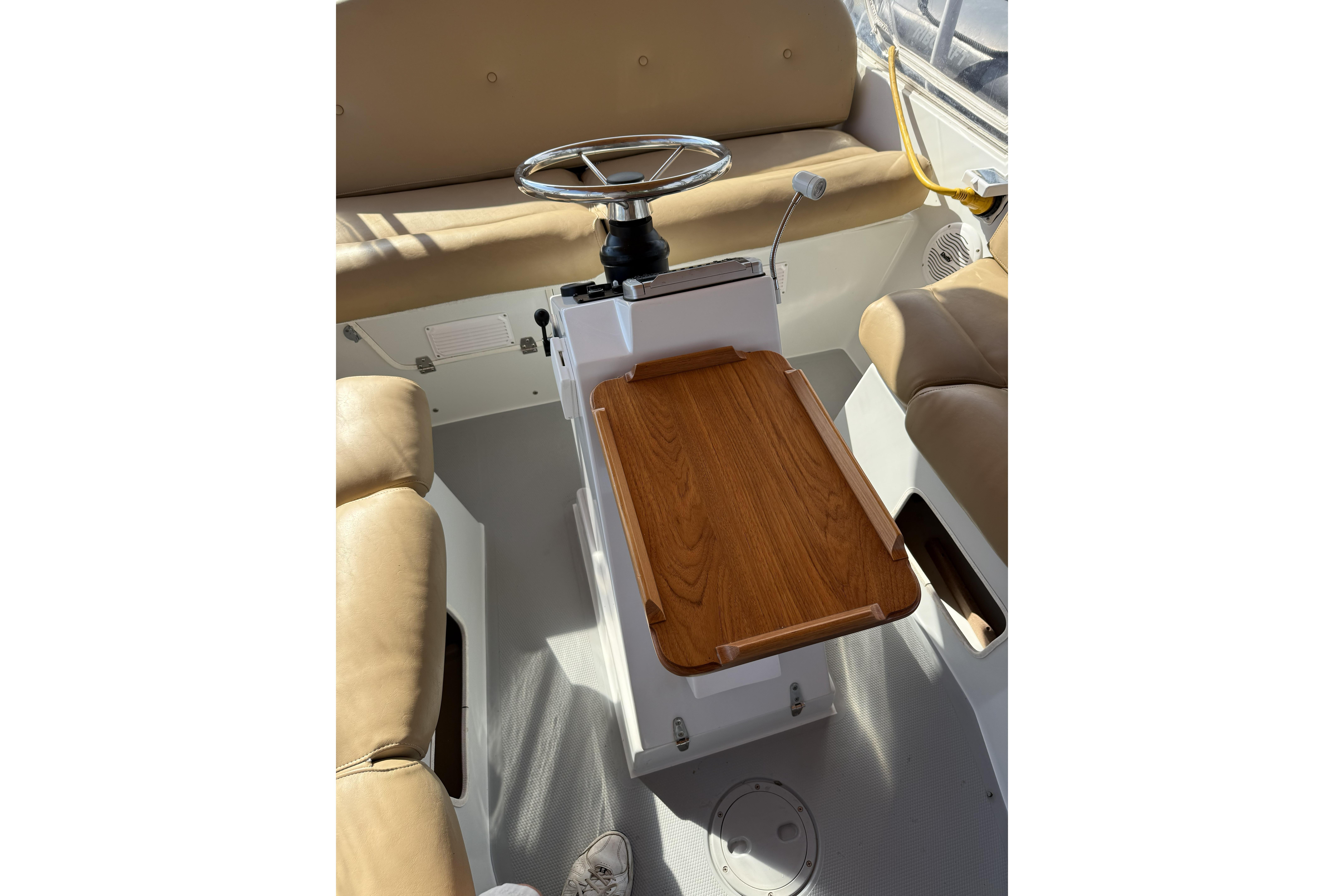 Interior of a 2004 Duffy 21 Classic boat with beige seating and wooden table.