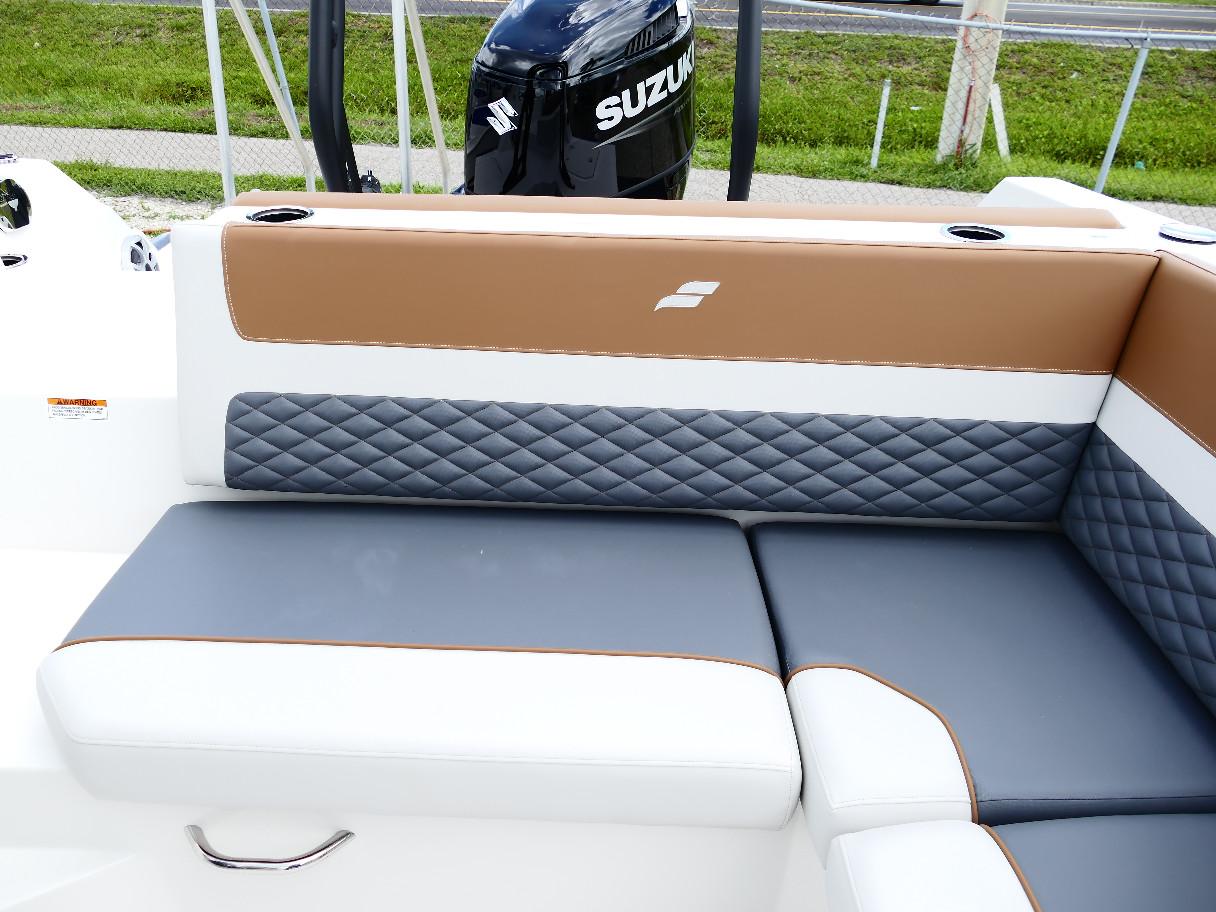 2026 Starcraft SVX 231 OB boat interior with stylish quilted seating and Suzuki outboard motor.