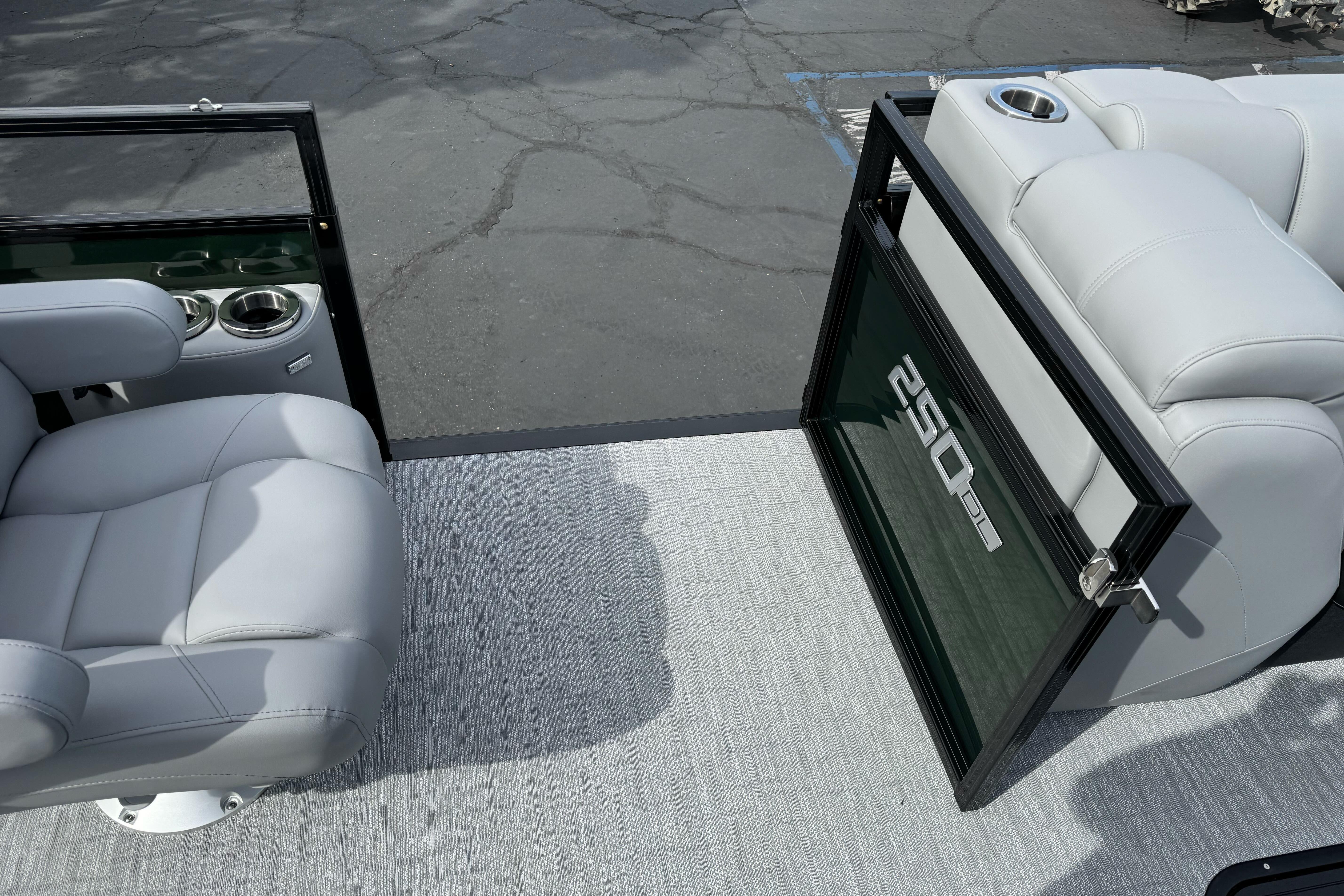 2026 Regency 250 DL boat interior with plush seating and cup holders.