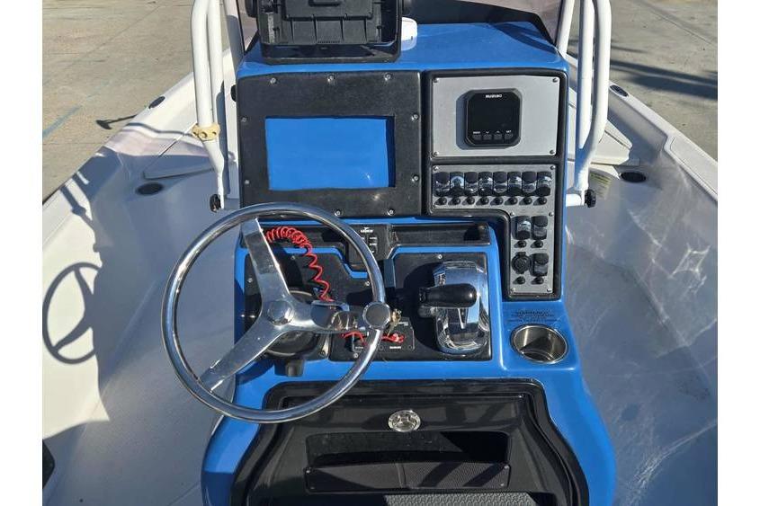 Center console of 2020 Blue Wave 2400 PureBay boat with steering wheel and controls.