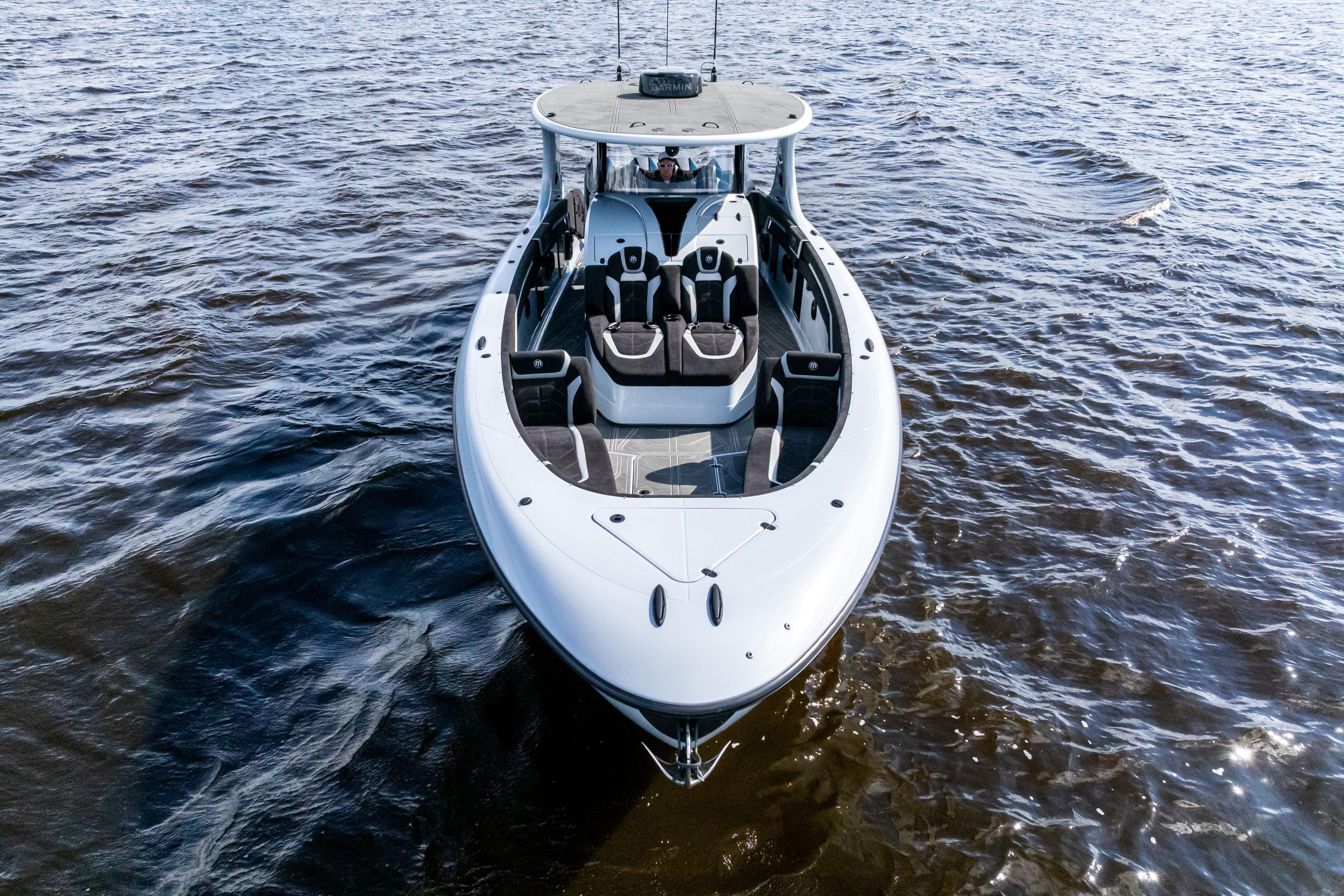 2027 Mystic Powerboats M4200 cruising on open water, showcasing sleek design and luxury features.