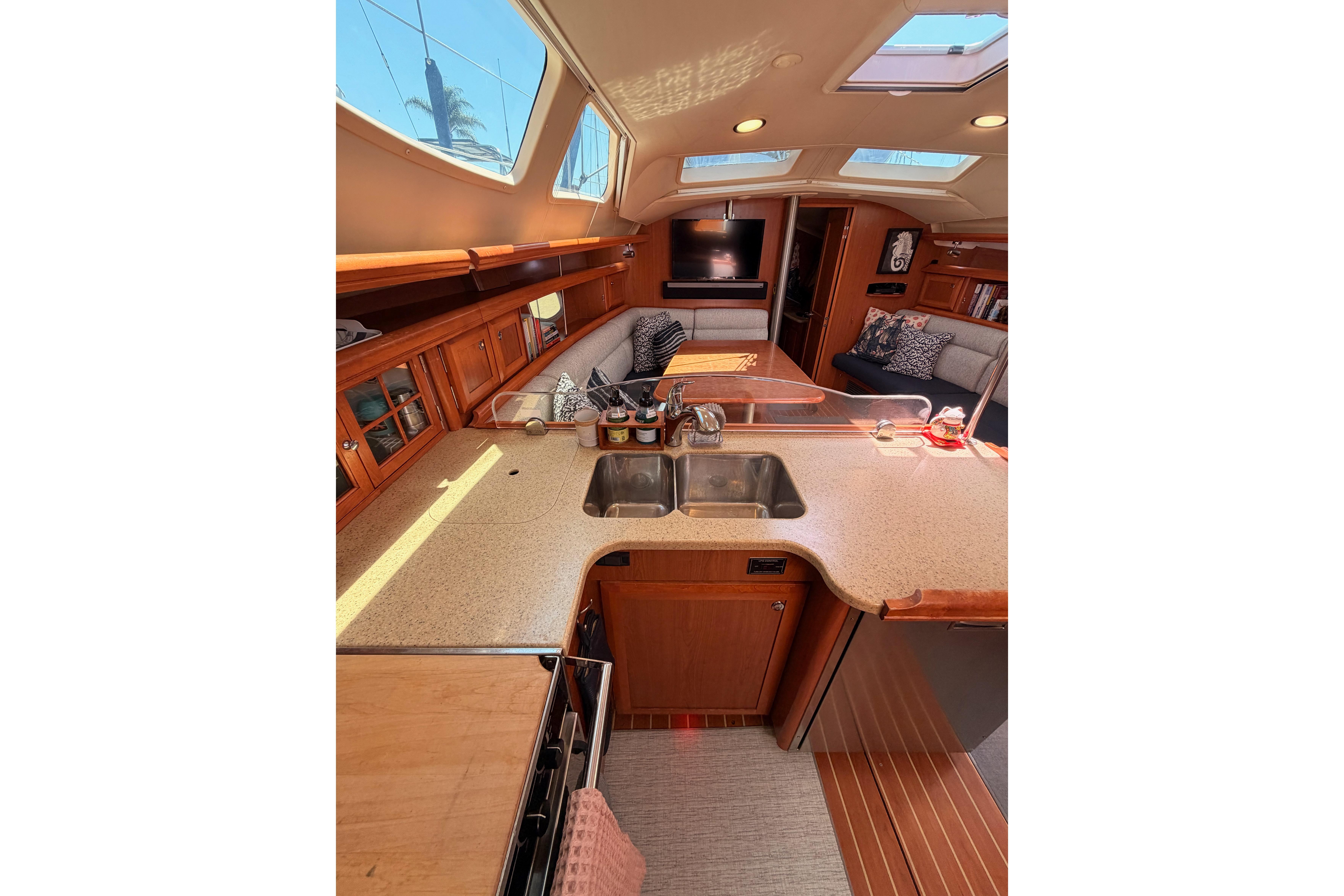 Interior of 2008 Hunter 45 Deck Salon yacht with modern kitchen and cozy seating area.