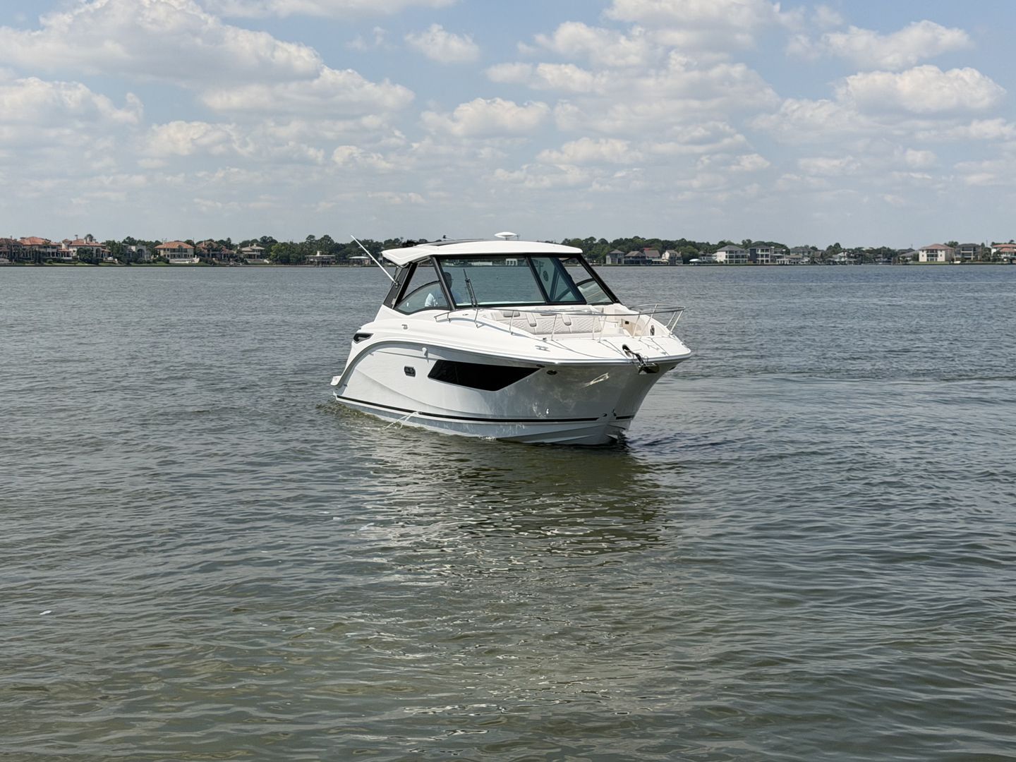 2026 Sea Ray Sundancer 320 Outboard on calm waters.