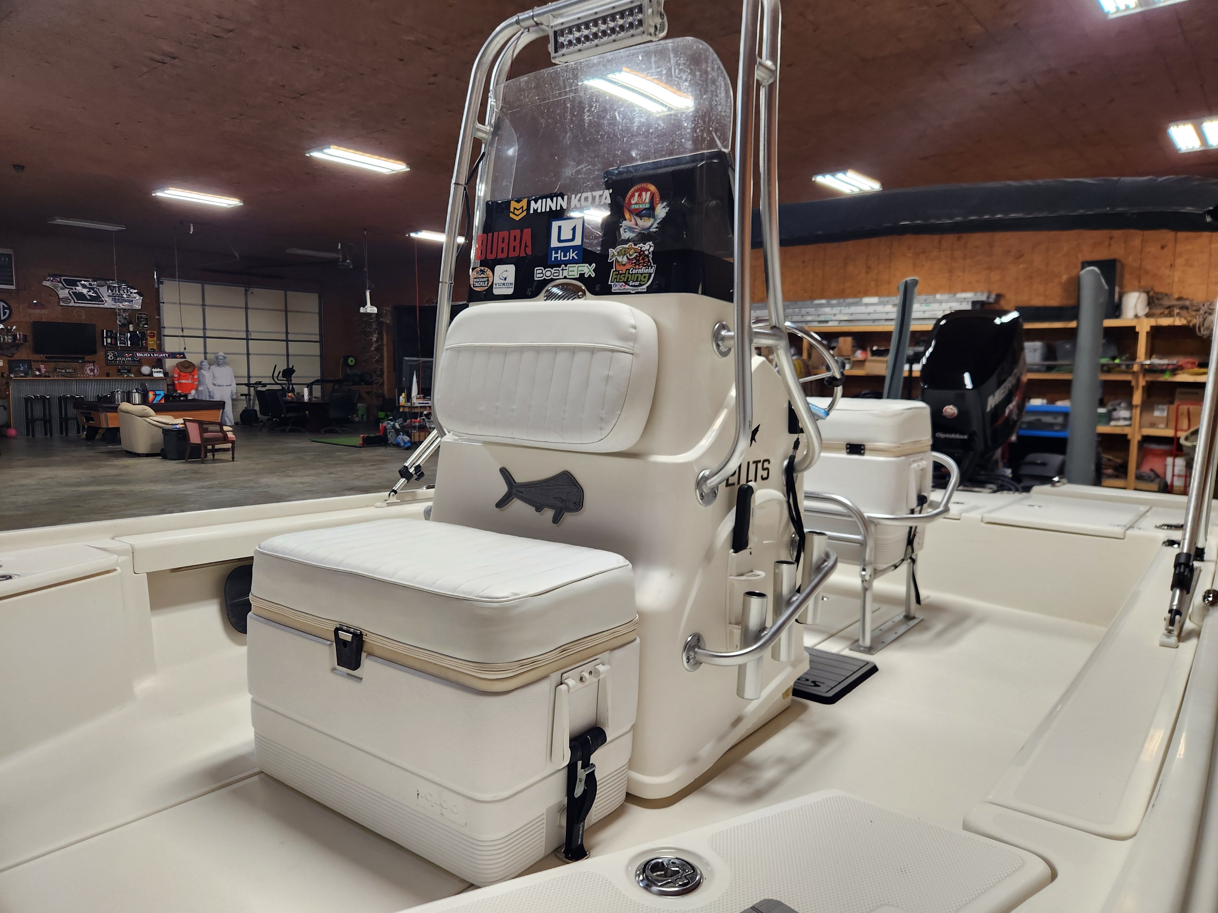 Interior view of a 2014 Mako 21 LTS boat in a warehouse.