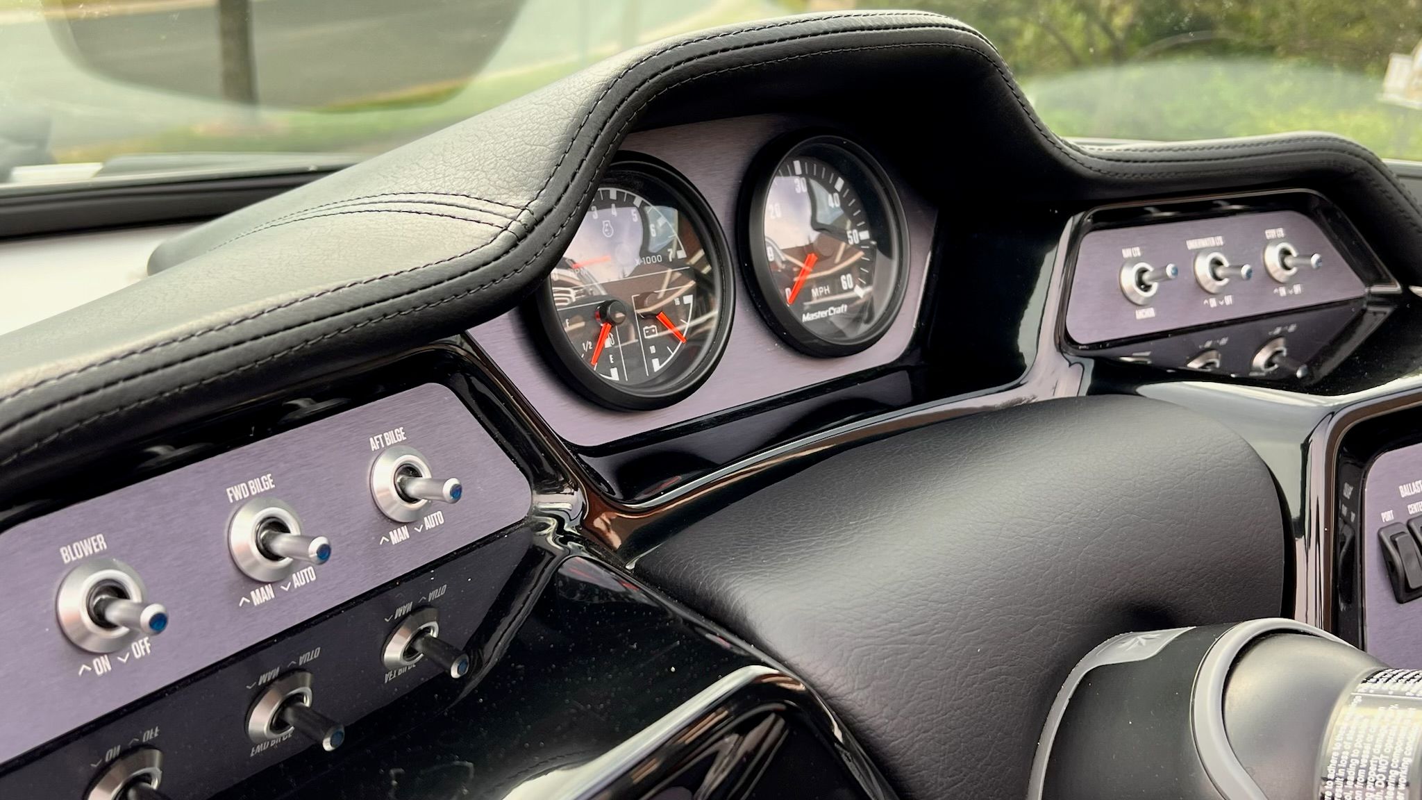 The dashboard of a 2020 MasterCraft NXT22 with analog gauges and toggle switches.