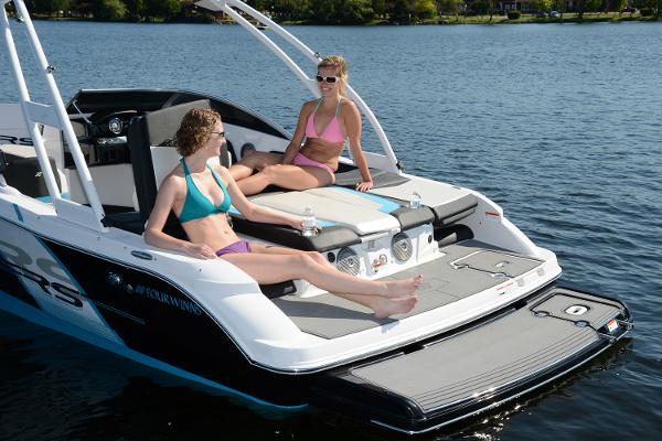 Manufacturer Provided Image: 2016 Four Winns H200RS boat with two women relaxing on the deck.