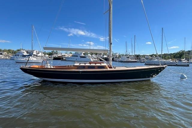 Sailboat on water, Morris 36 model, 2006, docked in a marina under clear blue sky.