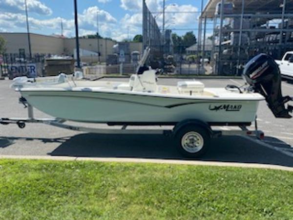 2024 Mako Pro Skiff 15 CC boat on trailer, parked outdoors.