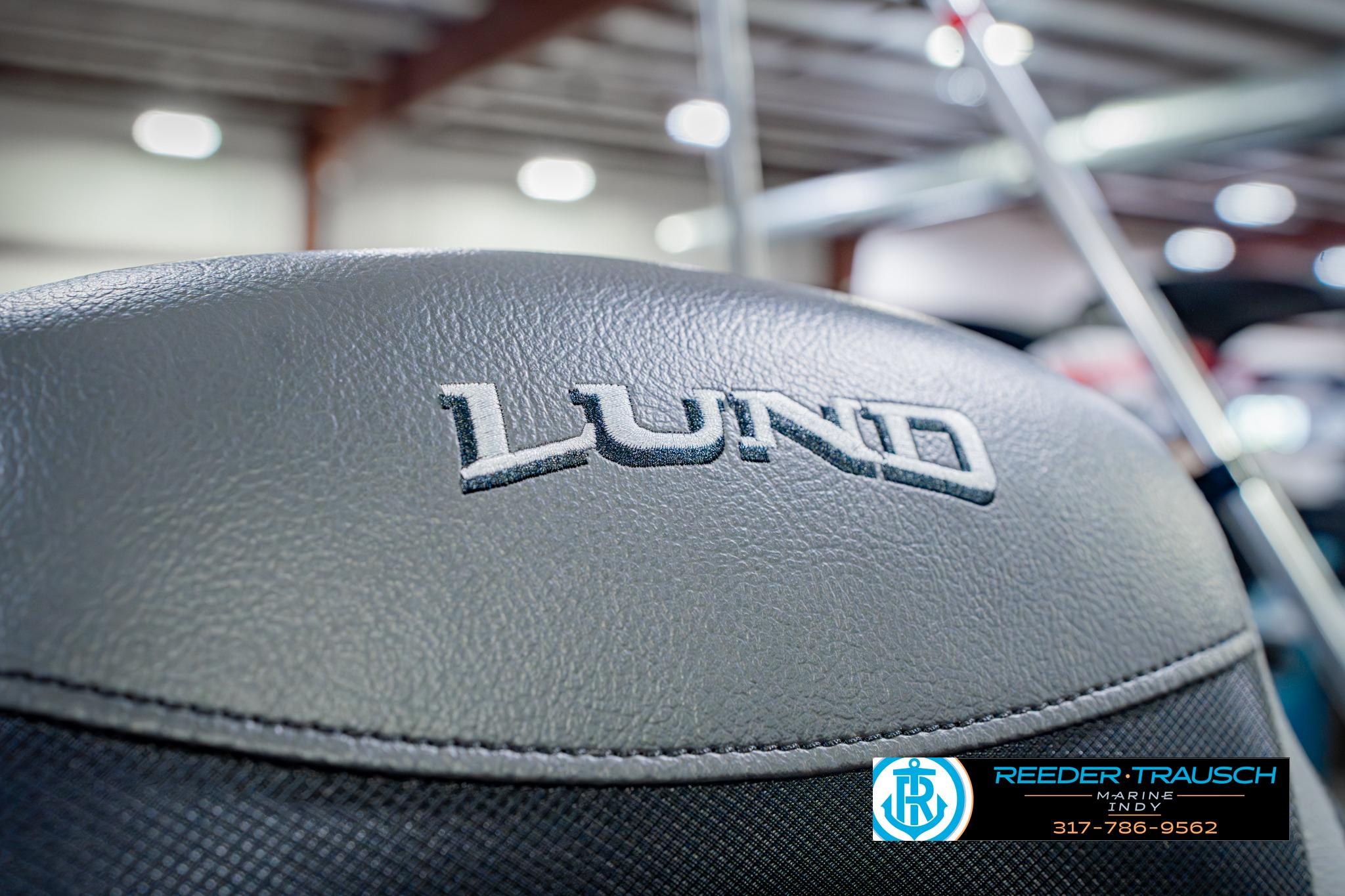 2026 Lund 1875 Impact XS boat seat with logo in showroom setting.
