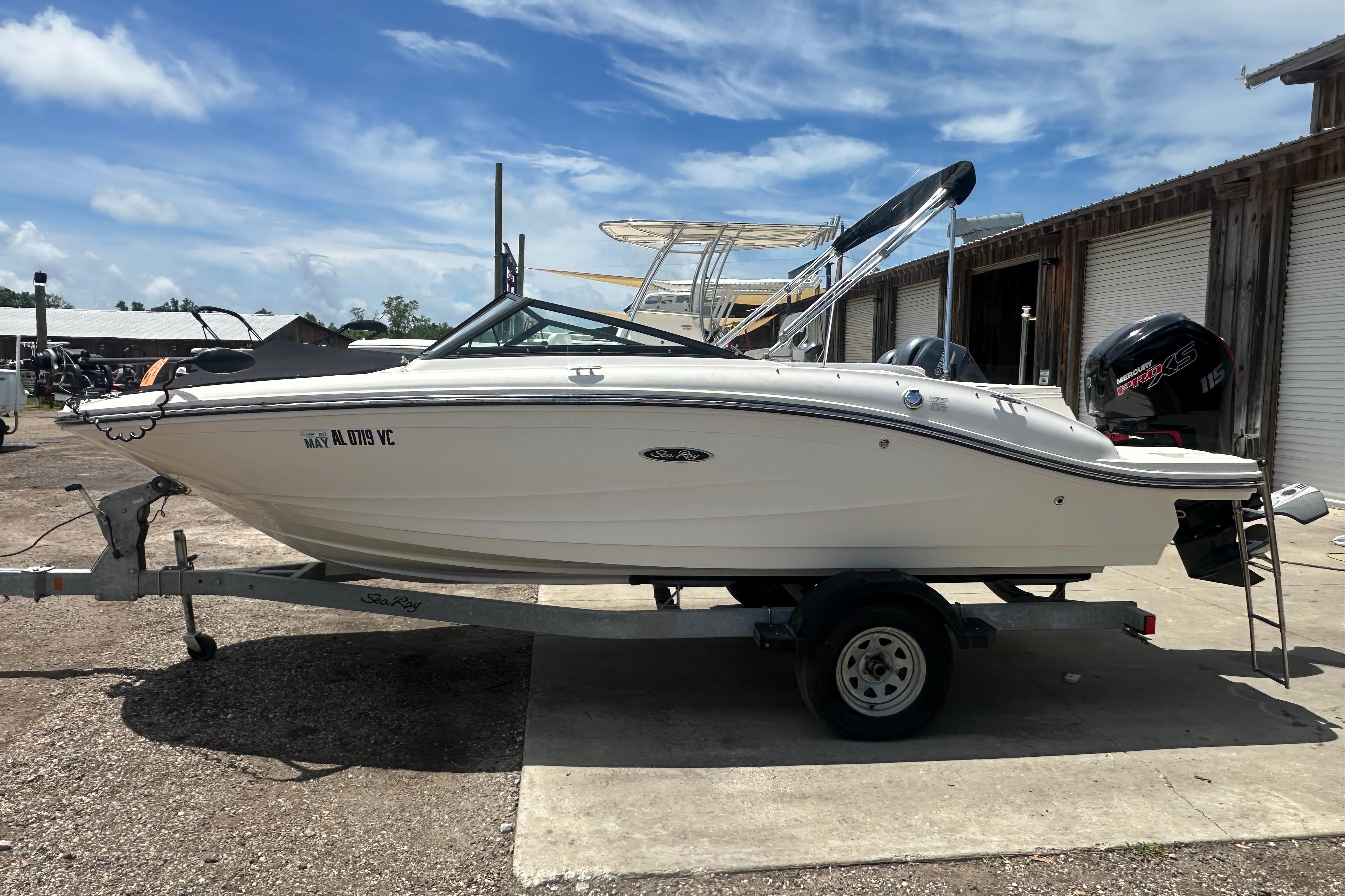 2017 Sea Ray SPX 190 Outboard boat on trailer, parked outdoors under blue sky.