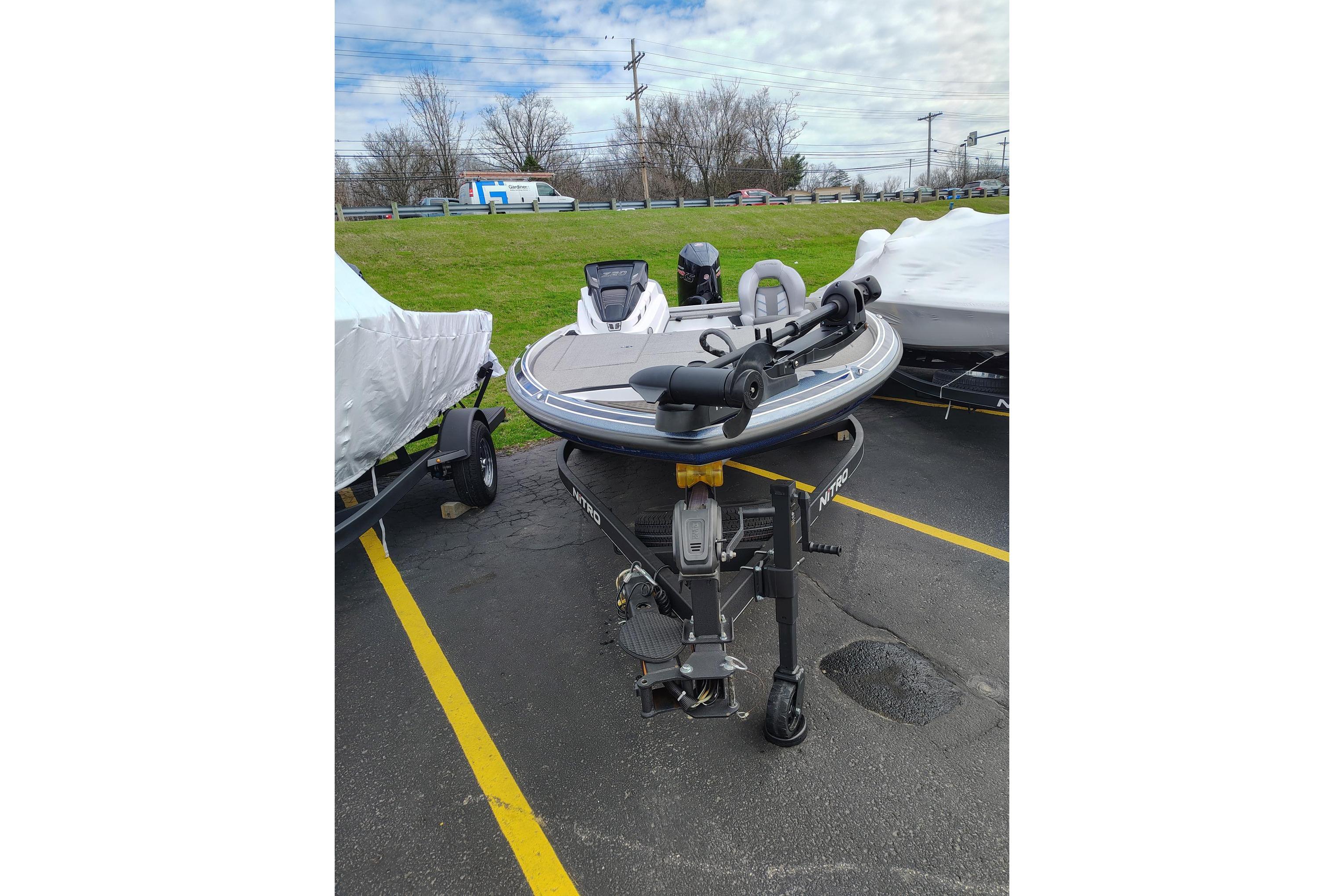 2024 Nitro Z20 boat on trailer in parking lot, ready for transport.