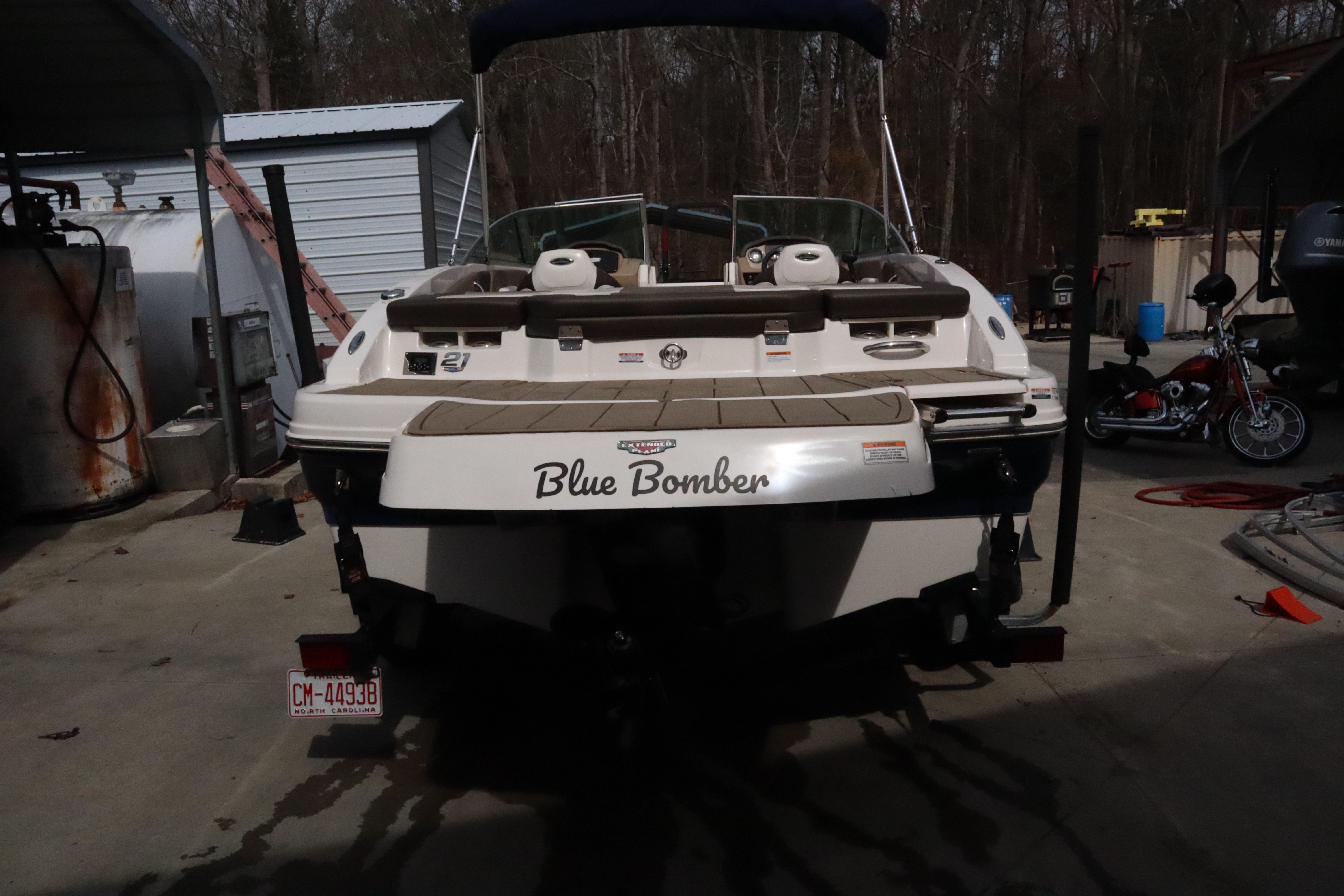 2021 Chaparral 21 SSi boat named "Blue Bomber" parked in a garage.