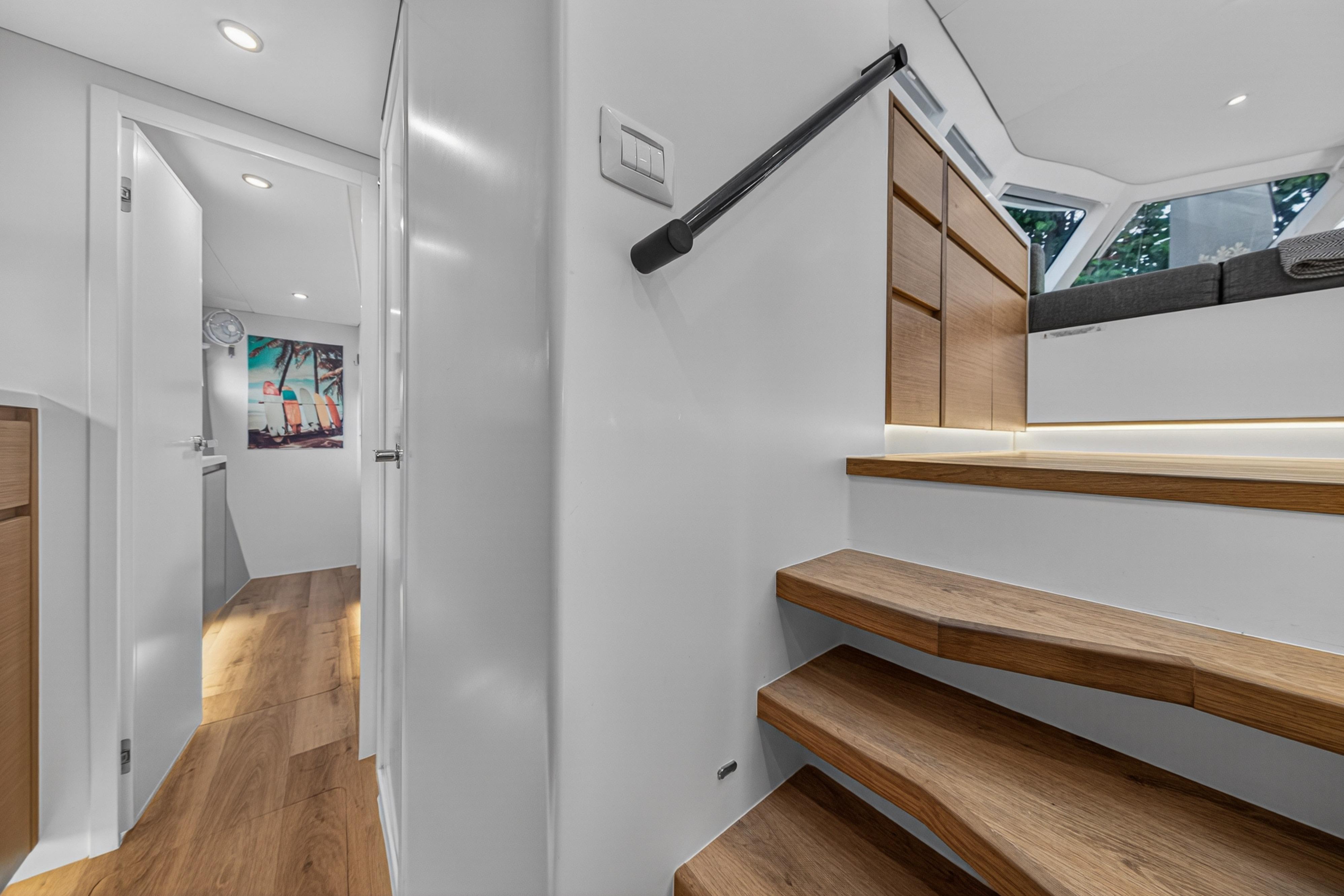 Modern interior of Balance 482 yacht, featuring wooden stairs and sleek design, 2023 model.