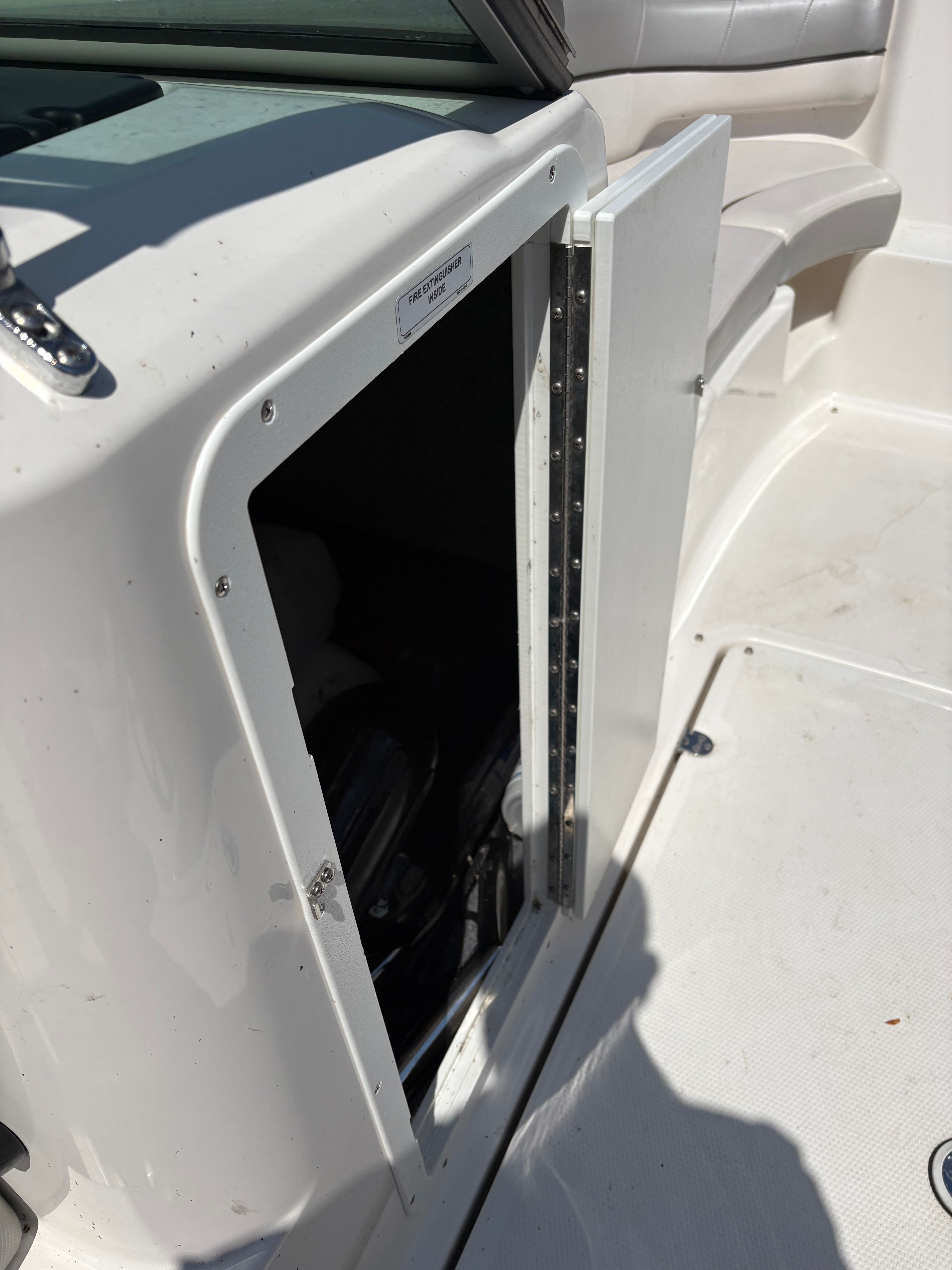 Open storage compartment on a 2012 Yamaha AR210 boat.
