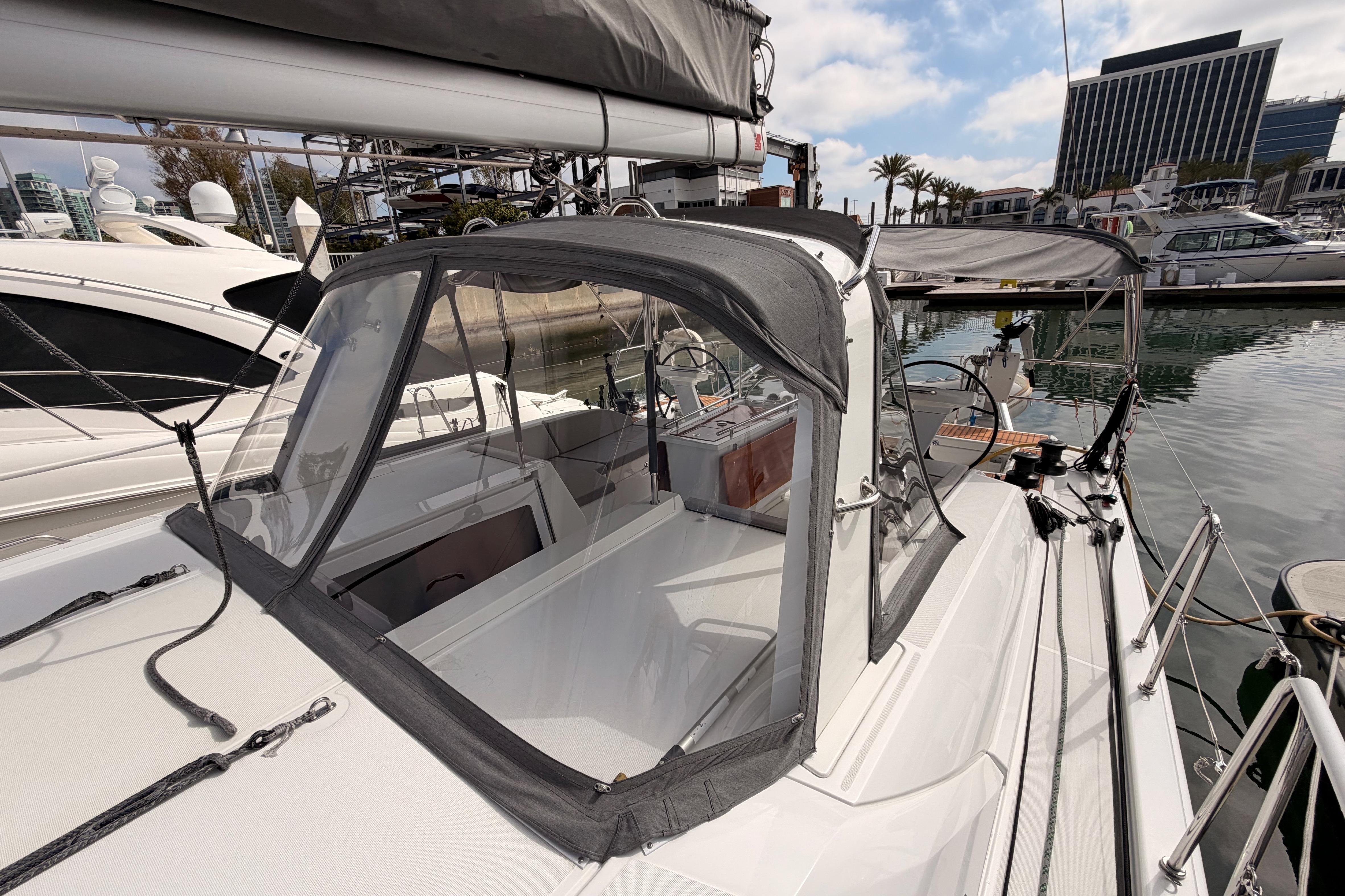 2020 Beneteau Oceanis 46.1 sailboat docked in marina, featuring cockpit enclosure.