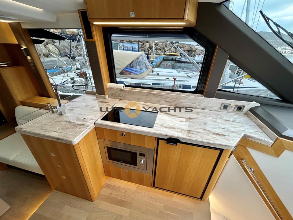 Modern kitchen interior of 2021 Galeon 400 Fly yacht with sleek countertops and appliances.