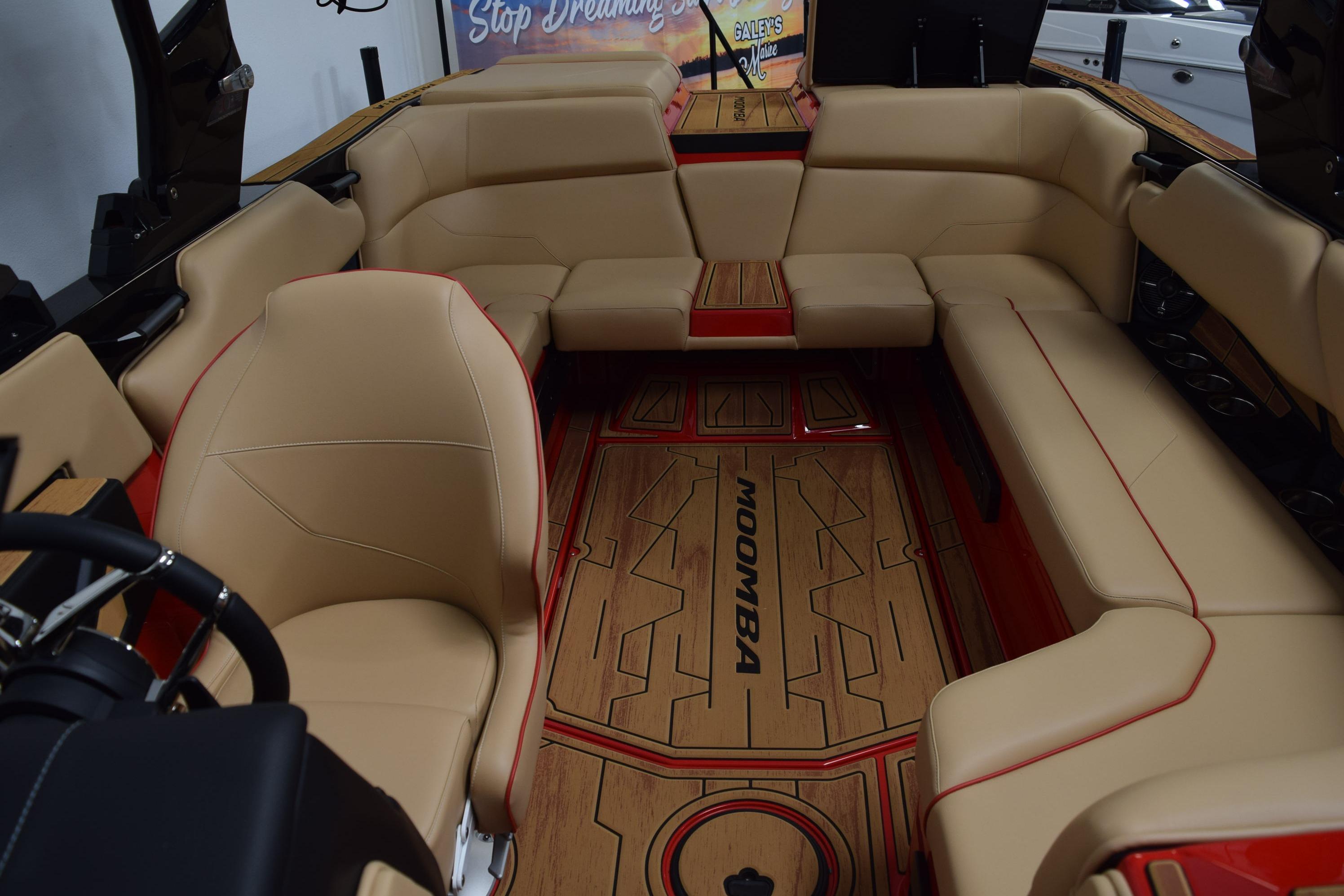 Luxurious interior of 2026 Moomba Max boat with beige seating and stylish wood flooring.