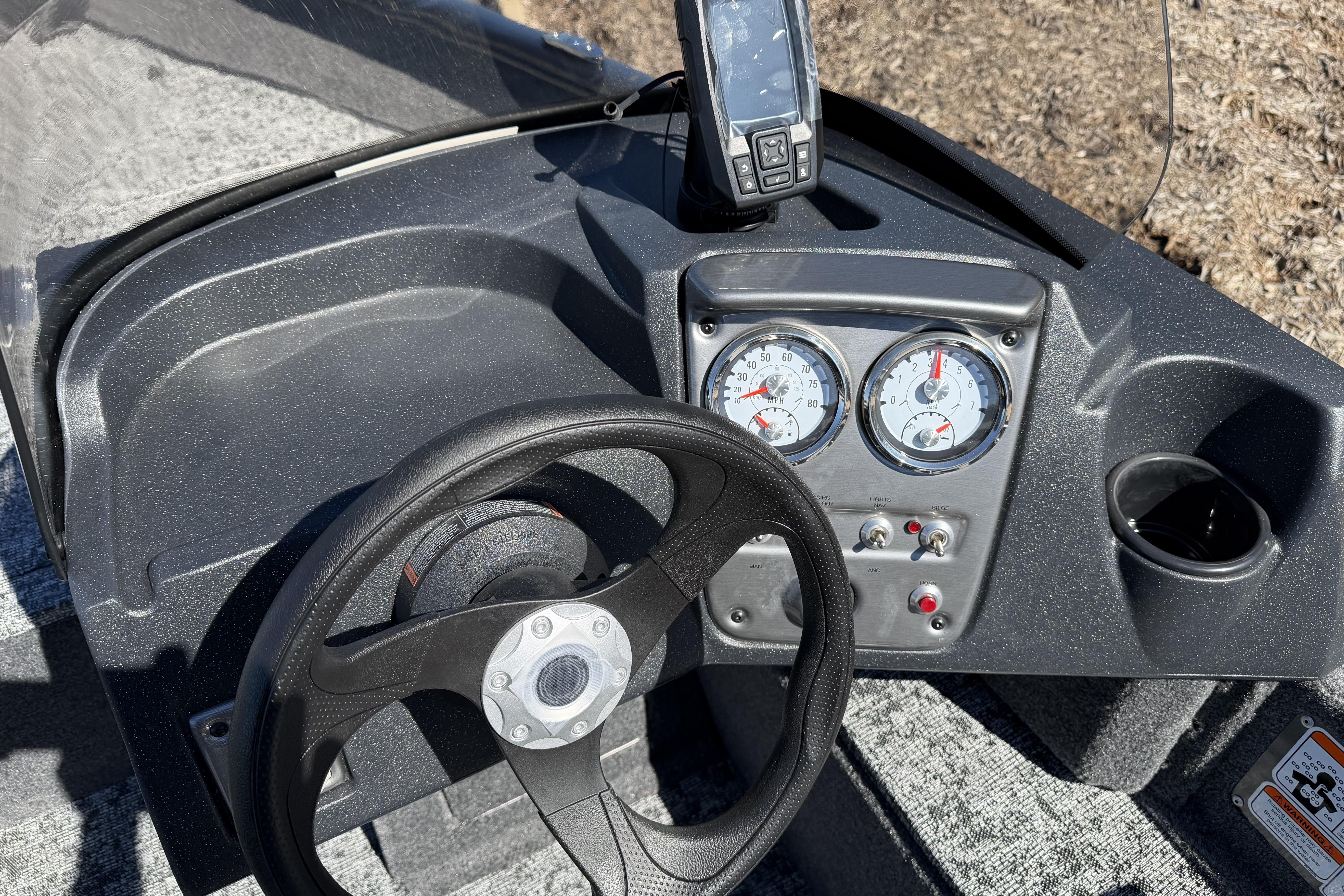 2026 Tracker Pro Guide V-16 SC boat dashboard with steering wheel and gauges.