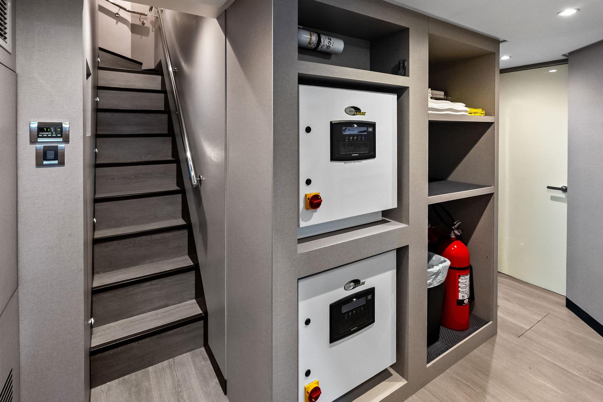 Interior of 2024 Ocean Alexander 35 Revolution yacht, featuring stairs and control panels.