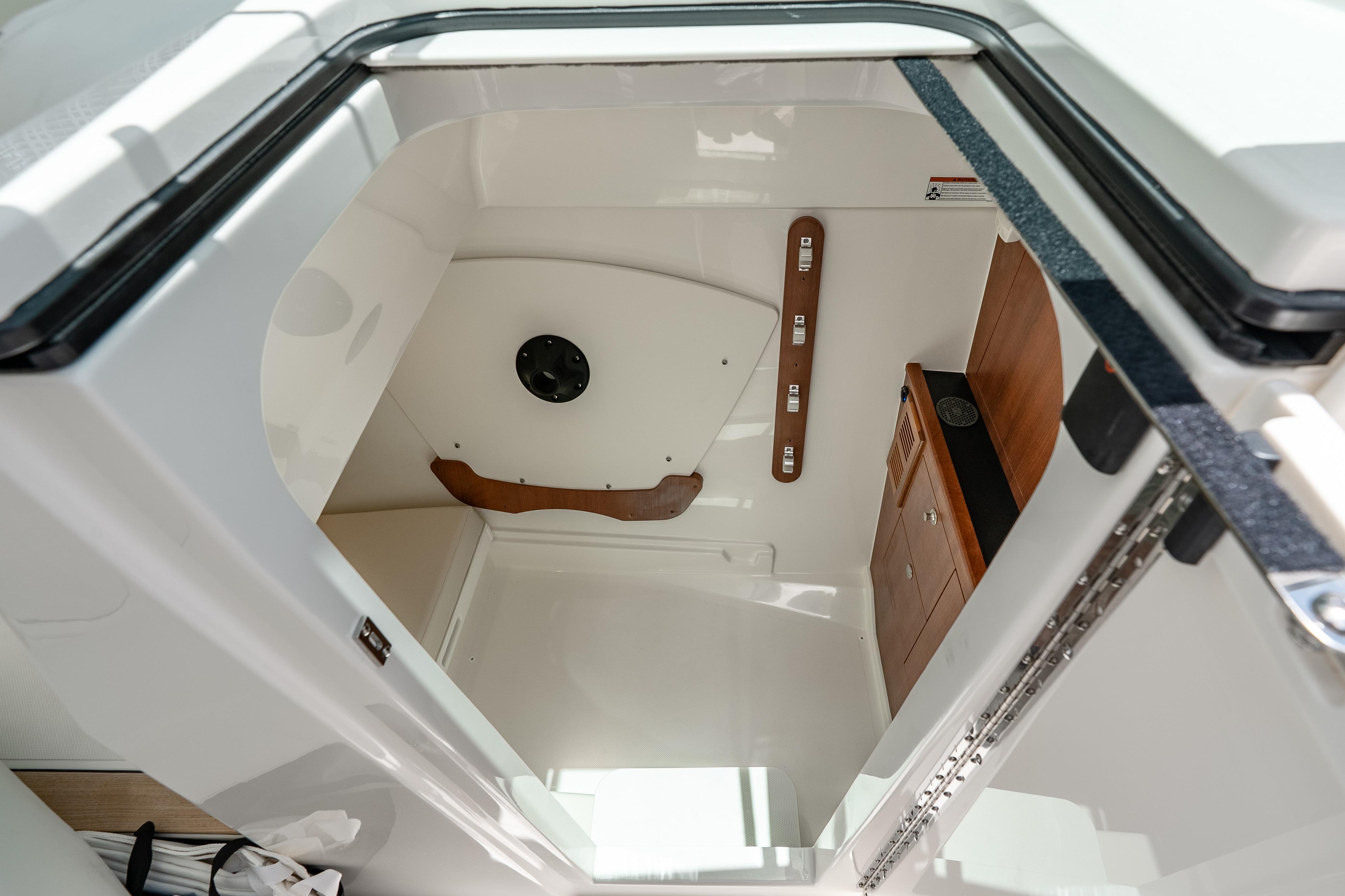 Interior cabin of 2026 Pursuit DC 326 Dual Console boat, featuring sleek design and wood accents.
