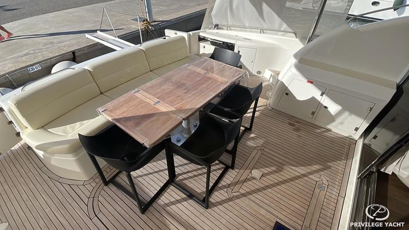 Luxurious Sunseeker Manhattan 74 yacht deck with seating and dining area, 2001 model.