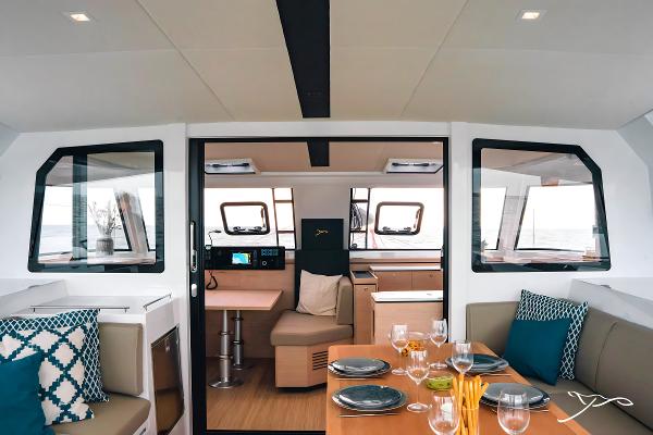 Interior of 2025 Nautitech 40 Open catamaran, featuring modern dining and navigation areas.