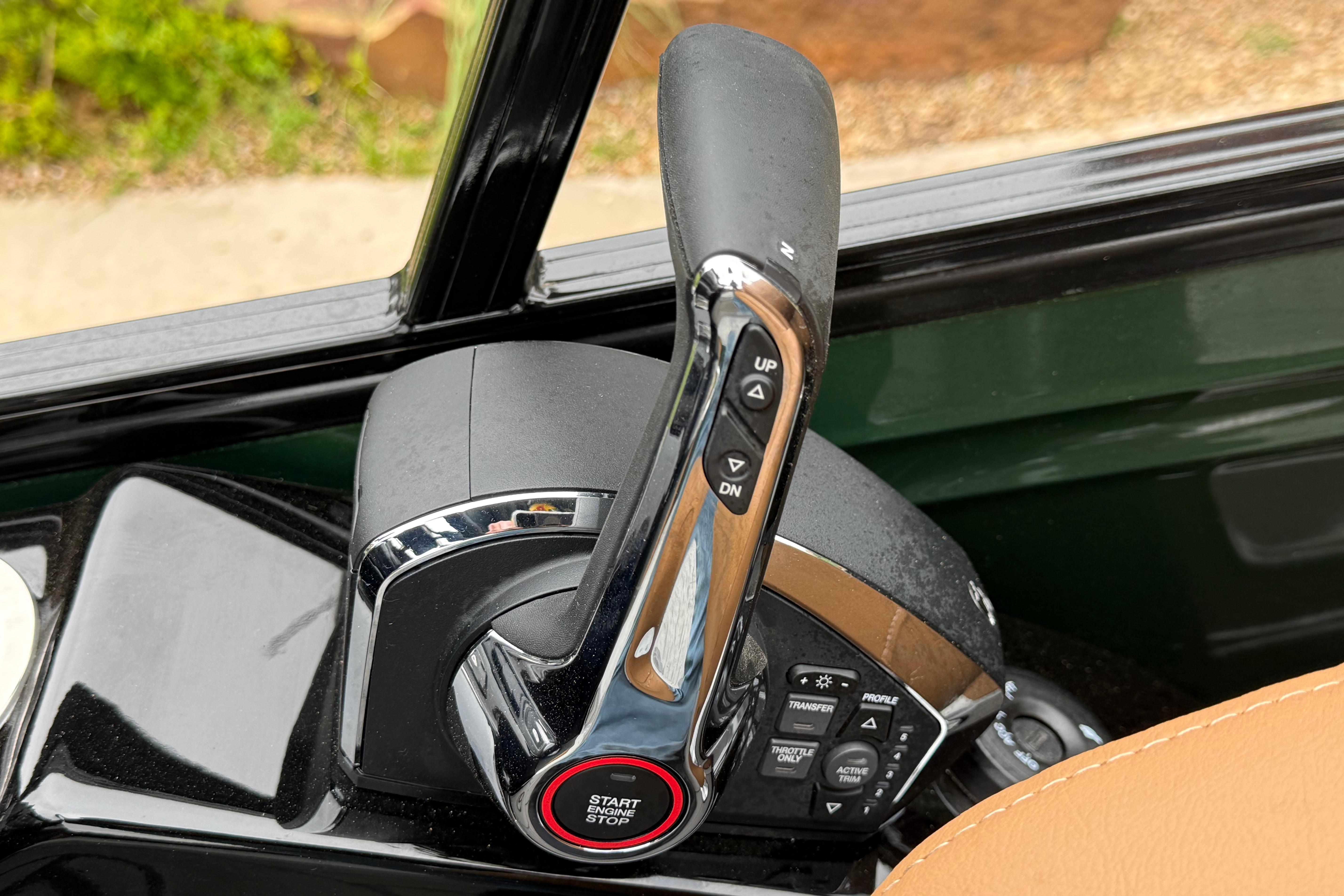Close-up of 2026 Regency 250 DL throttle control with start/stop button and adjustment switches.