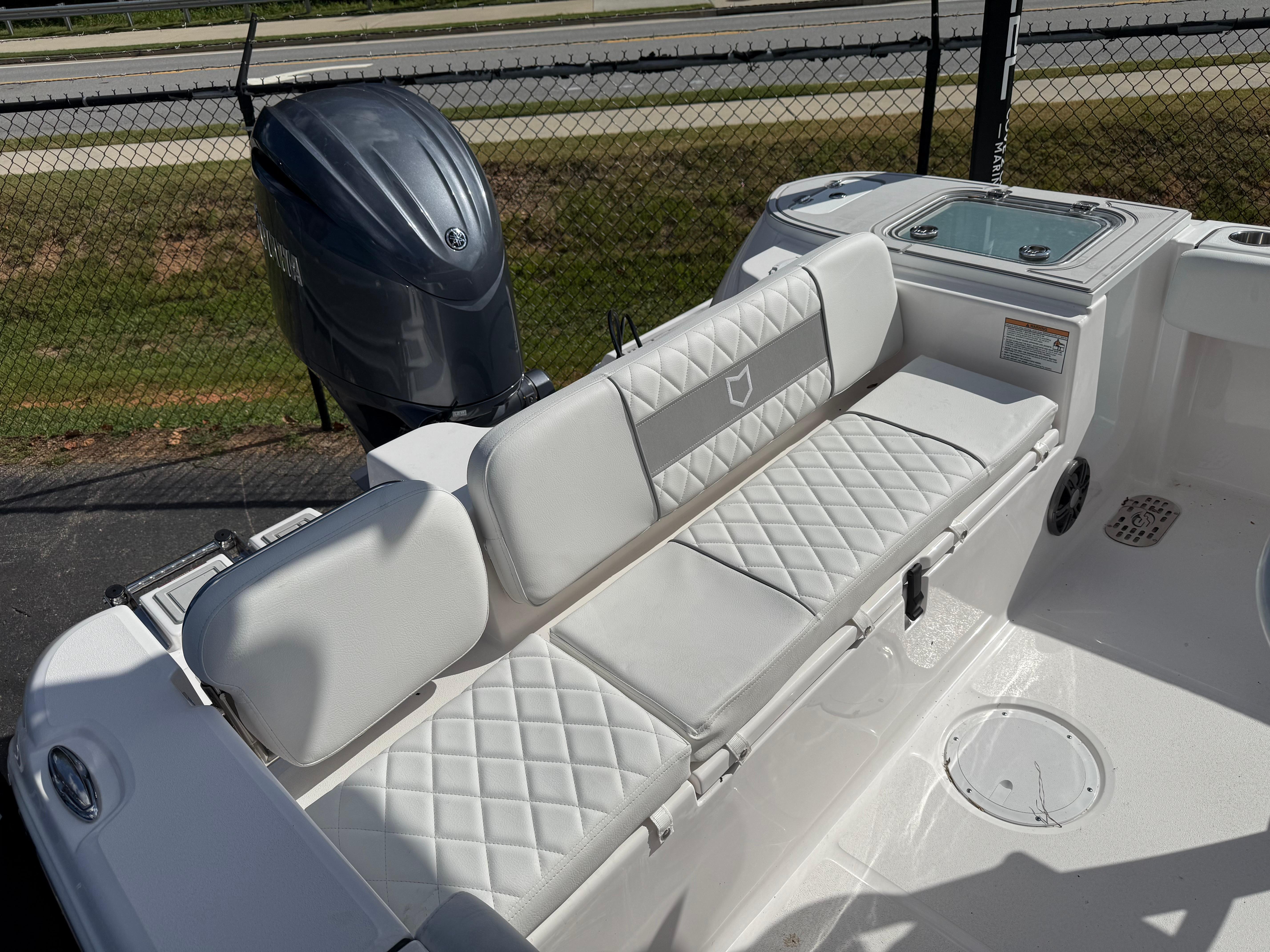 2026 Sea Fox 228 Commander boat with white seating and Yamaha outboard motor.