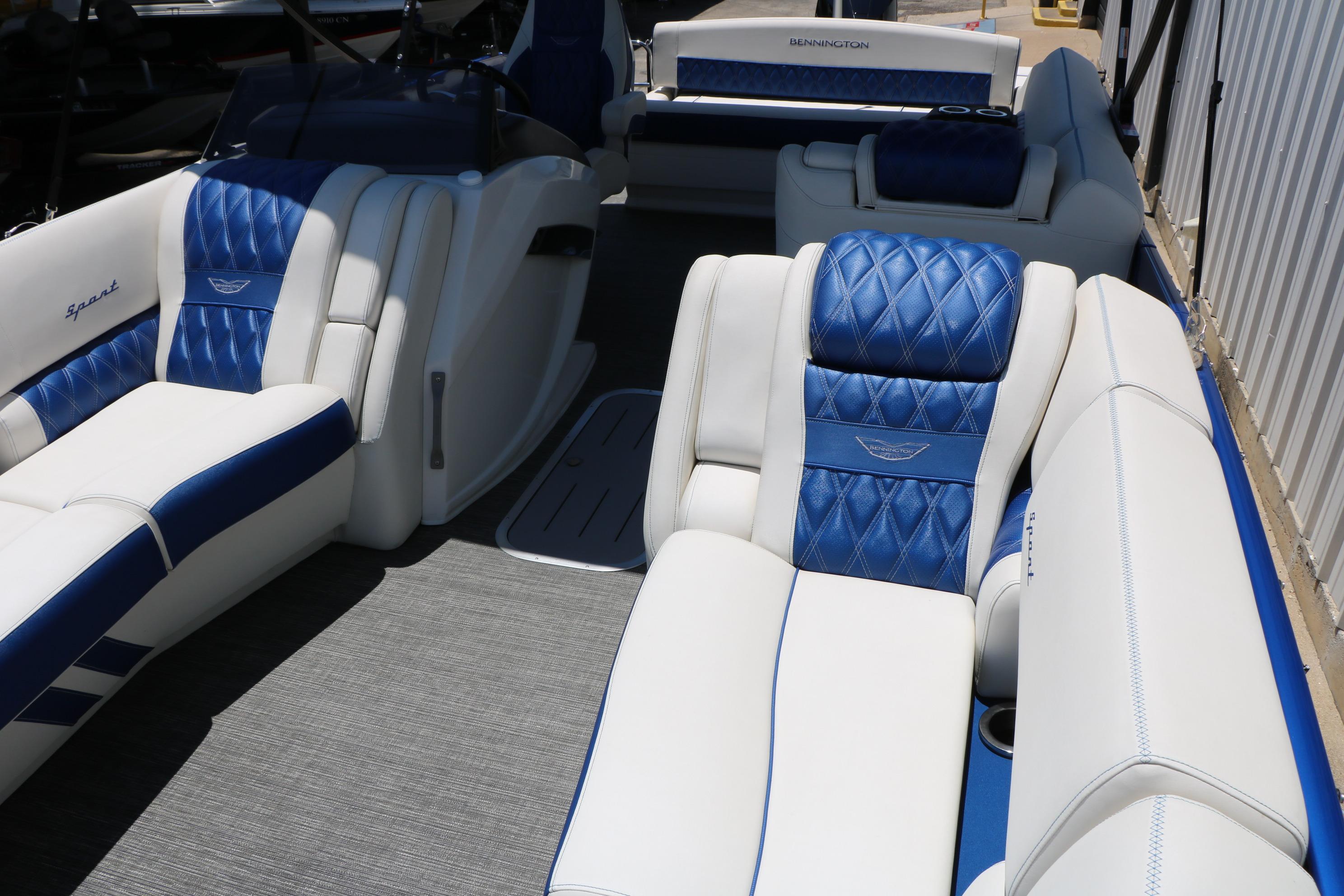 2024 Bennington 23 RX Swingback boat interior with luxurious blue and white seating.