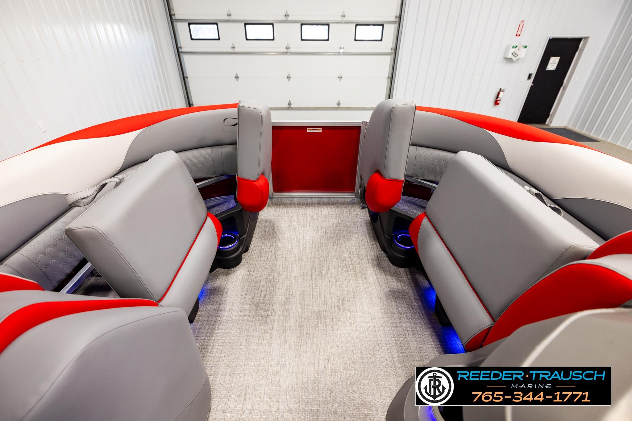 Luxurious interior of 2026 Avalon LSZ QL pontoon boat with red and gray seating.