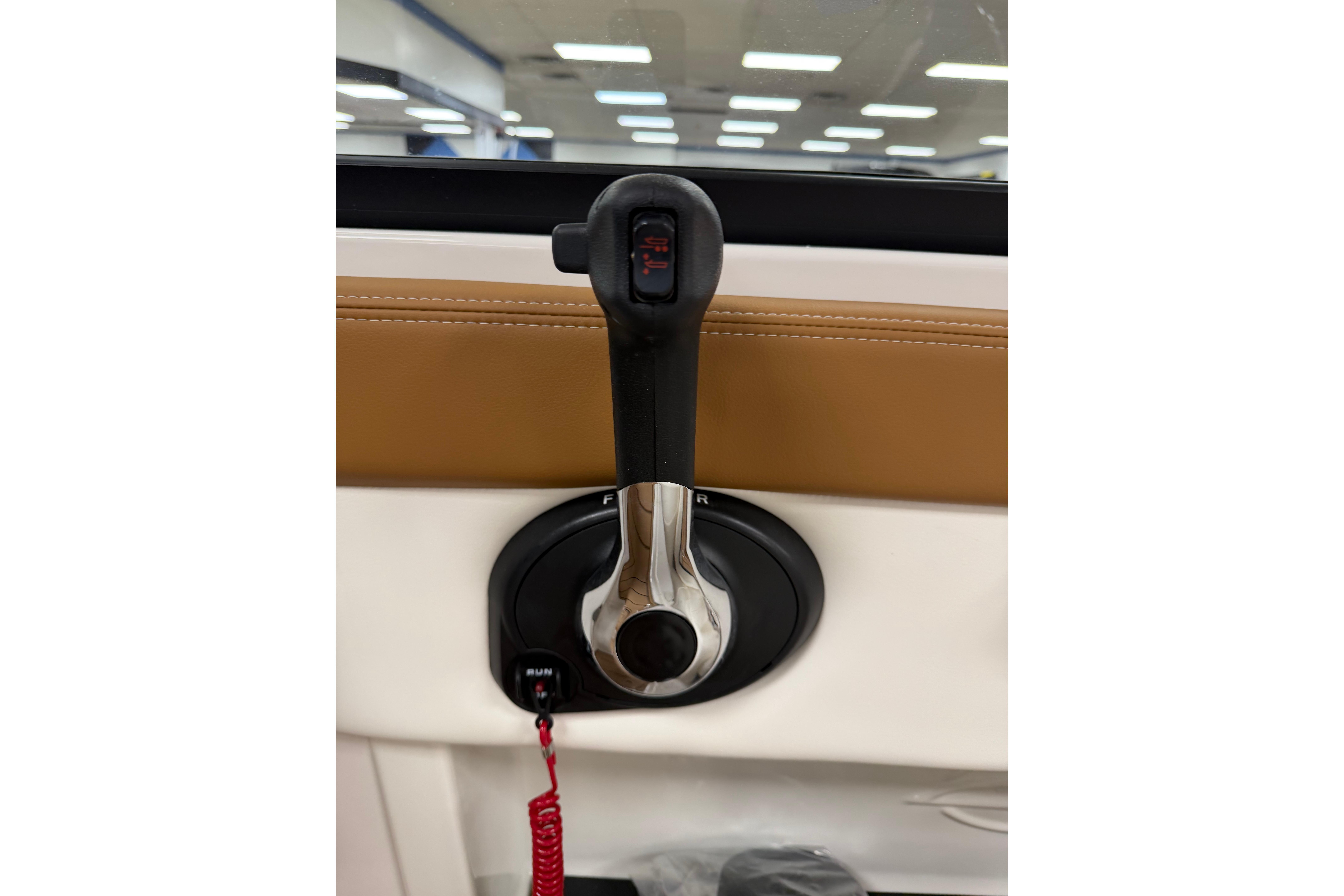 Throttle control lever of 2026 Chaparral 21 SSi Ski & Fish boat, featuring sleek design.