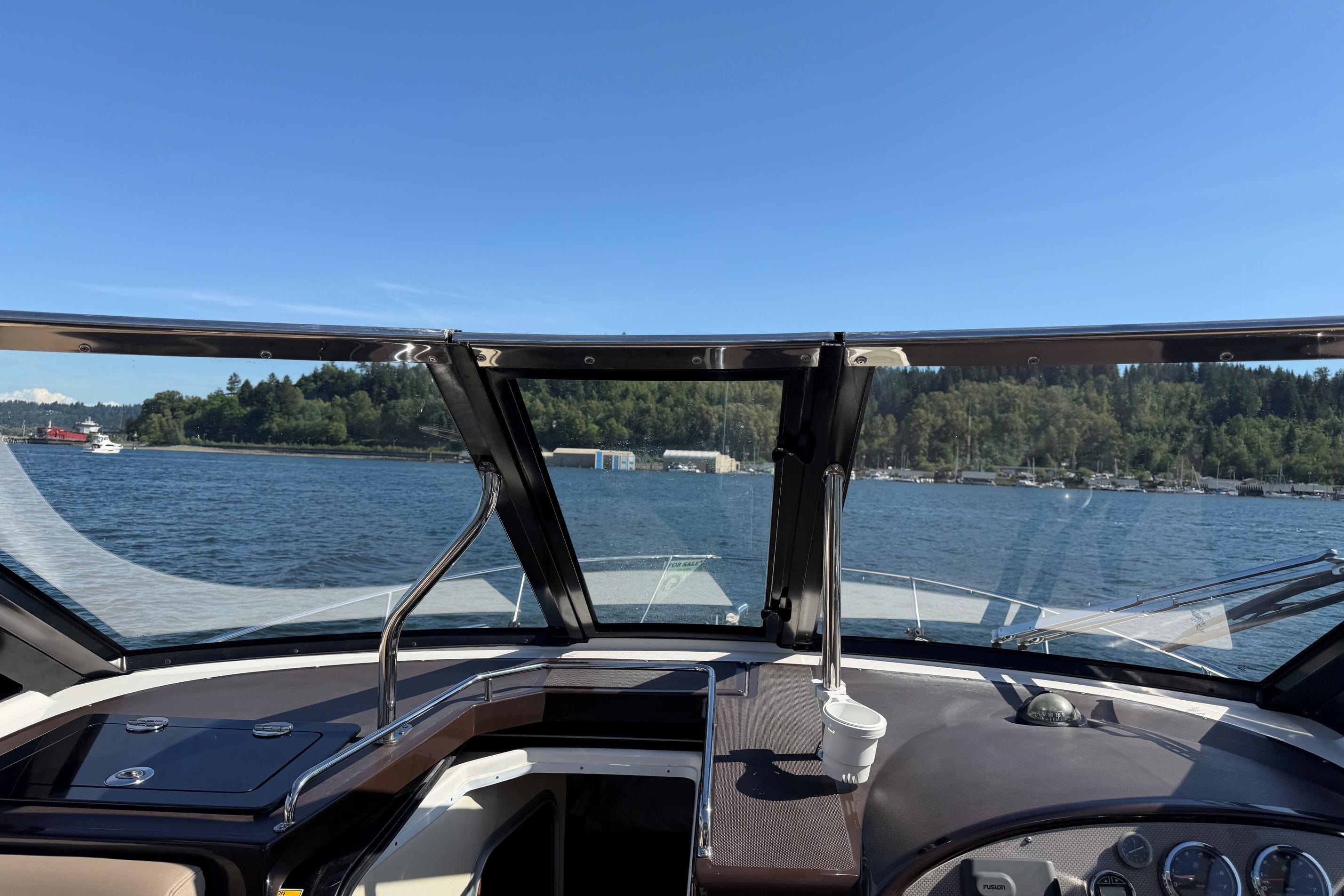 Cockpit view from a 2013 Regal 35 Sport Coupe on a sunny day at sea.