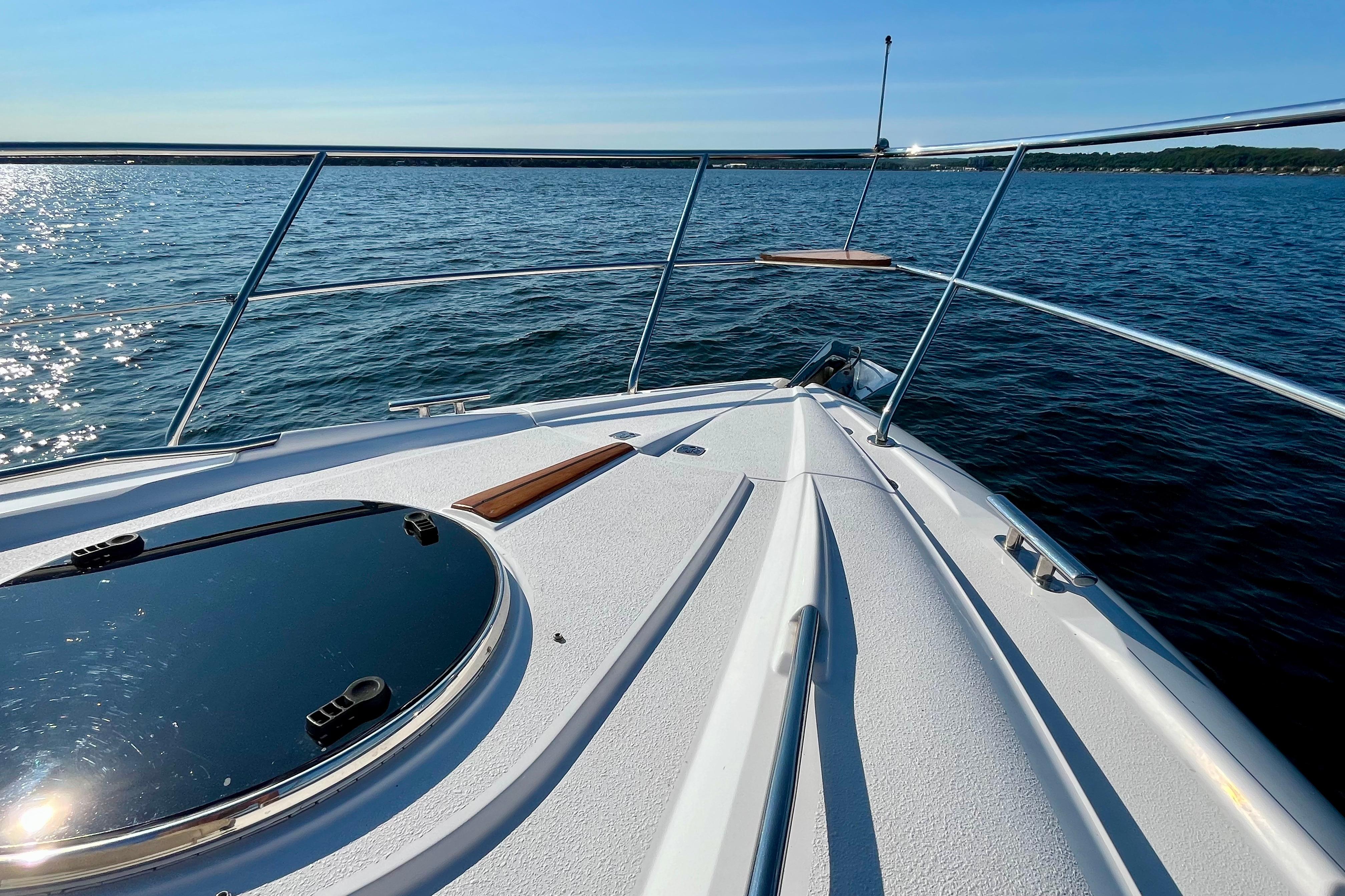 2007 Doral Alegria boat deck on calm blue water under clear sky.