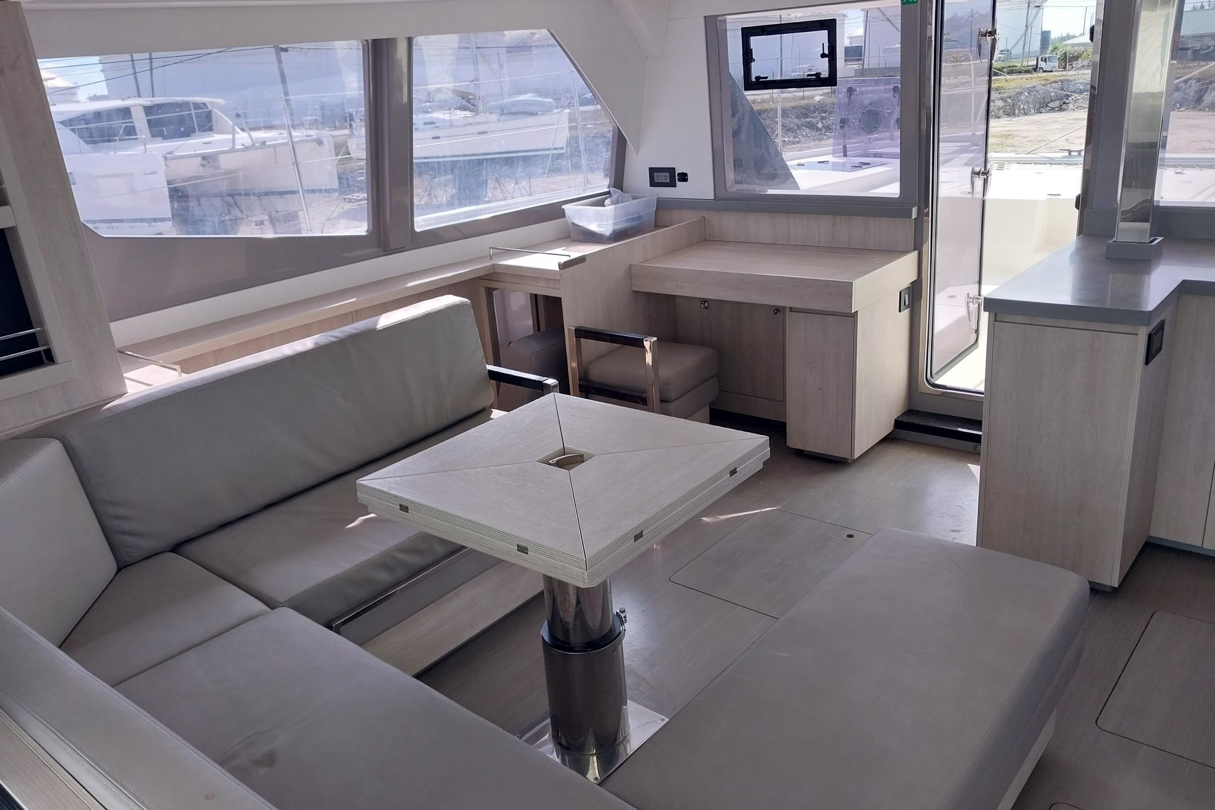 Luxurious interior of a 2020 Leopard 45 yacht with modern seating and large windows.