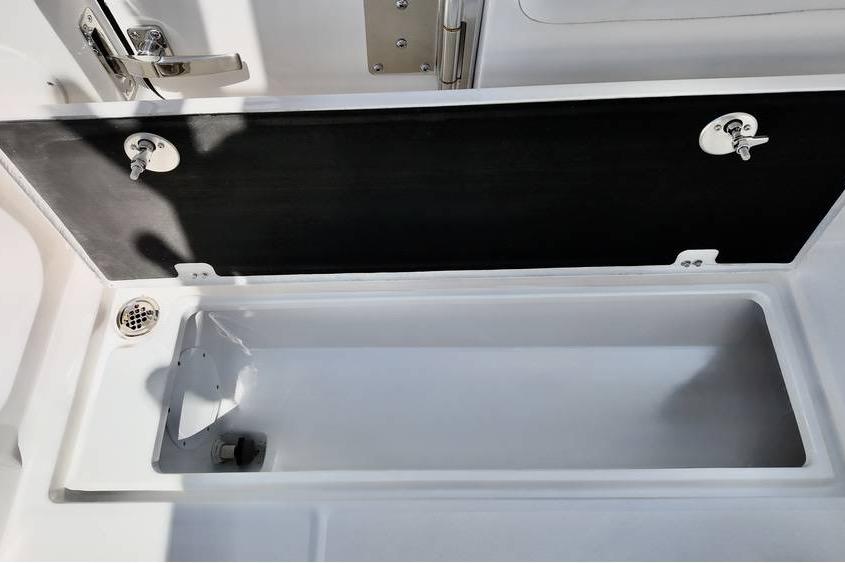 Storage compartment on 2026 Sea Fox 268 Commander boat, featuring secure latches and drainage system.