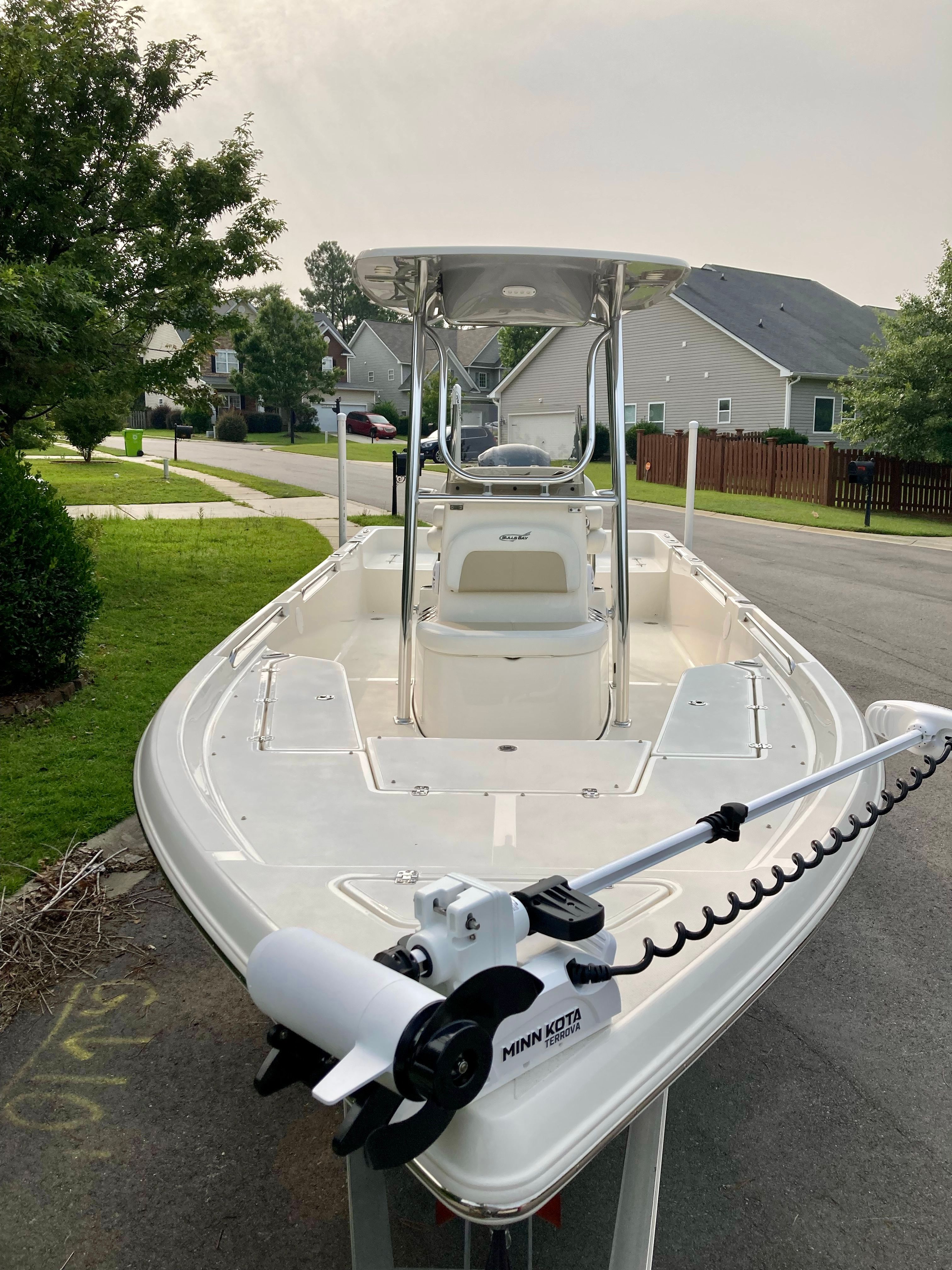 A 2023 Bulls Bay 2400 boat on a trailer in a residential area.