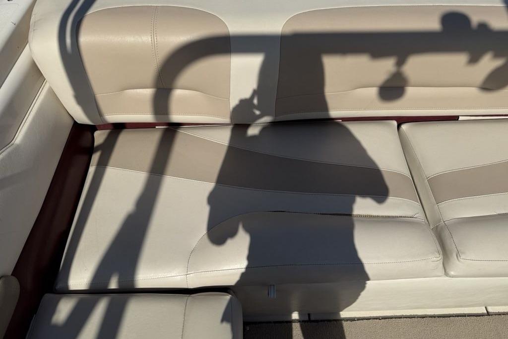 Beige leather seating on a 1999 Glastron GT 225 boat with shadow overlay.