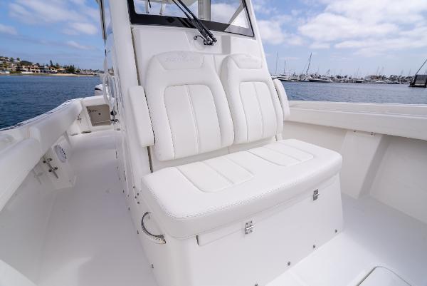 2025 Regulator 28 boat with white seating area by the water.