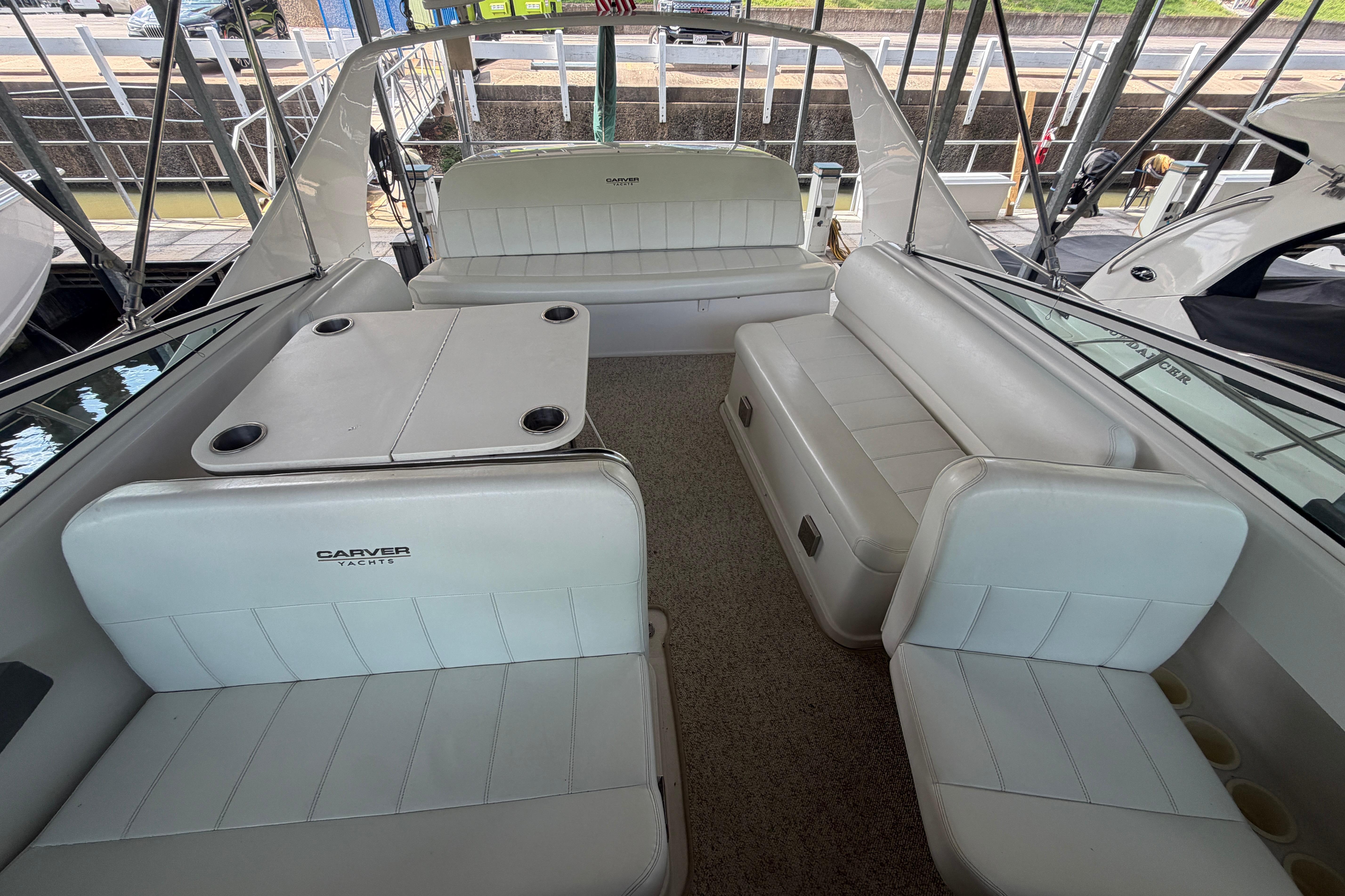 Interior of a 2000 Carver 350 Mariner yacht with white seating and table.